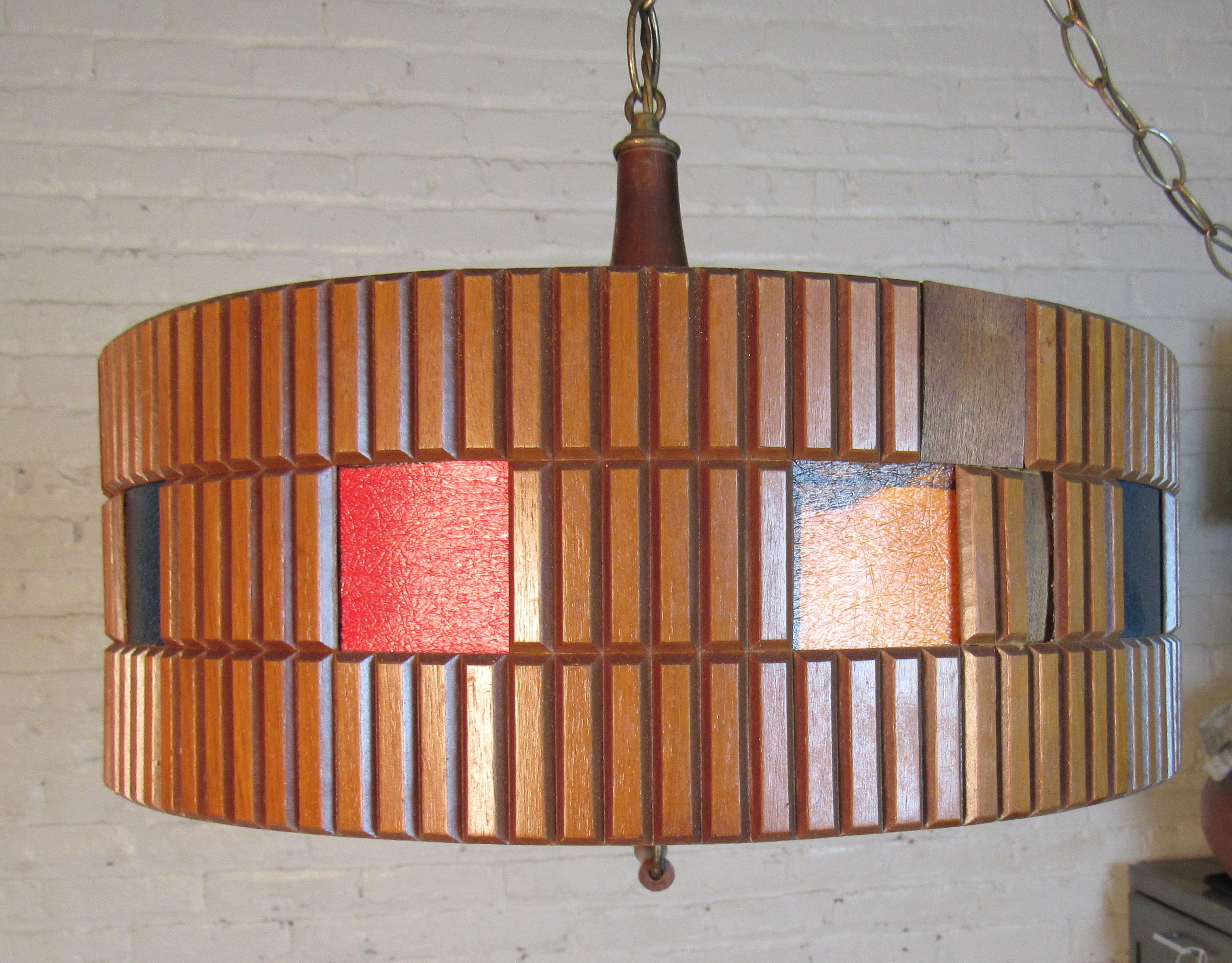 Mid-Century Modern sleek wooden chandelier featured in a circular shape. The outer frame is made up of colored wood and wood chips.

Please confirm item location NY or NJ with dealer.