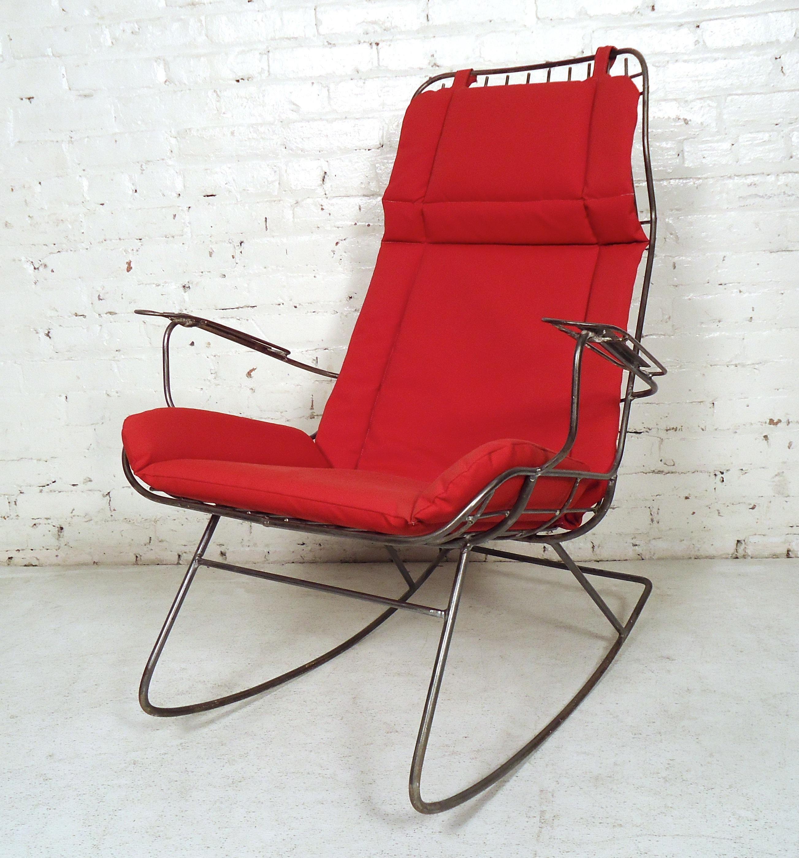 Unusual vintage modern iron rocker features red upholstered cushions.

Please confirm item location (NY or NJ) with dealer.
