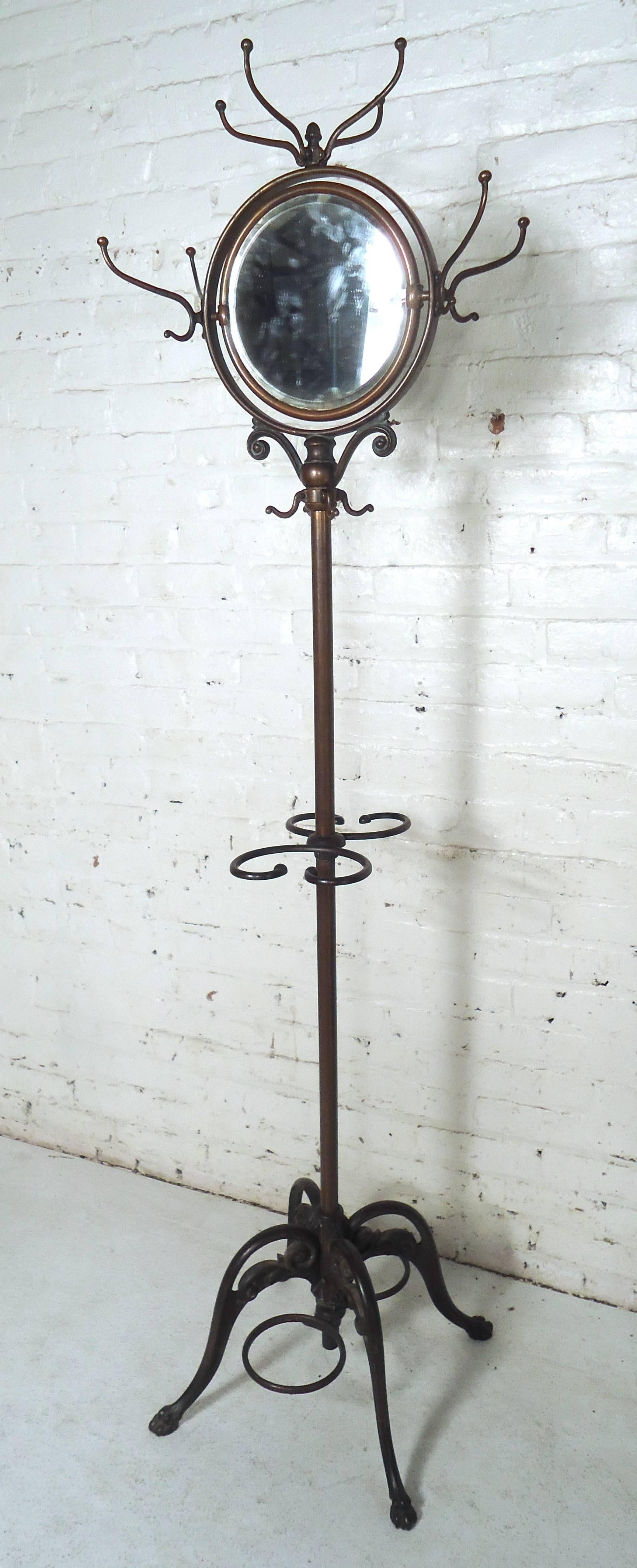 Antique iron coat rack features a cast iron base and oval mirrored top. Very unique and beautiful for home or office.

(Please confirm item location NY or NJ with dealer).