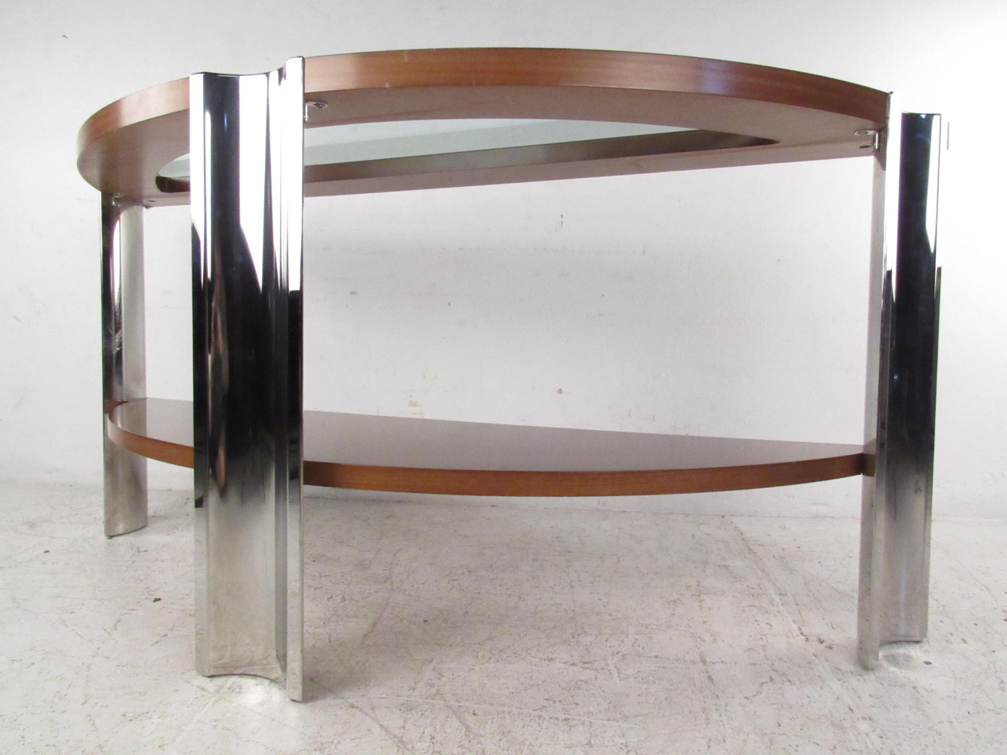 This elegant Mid-Century Modern console table features a tripod frame that's shaped like a half moon. An unusual Italian design made exclusively for Excelsior. A sturdy piece with chrome legs, gorgeous wood grain, and a beveled glass insert on the