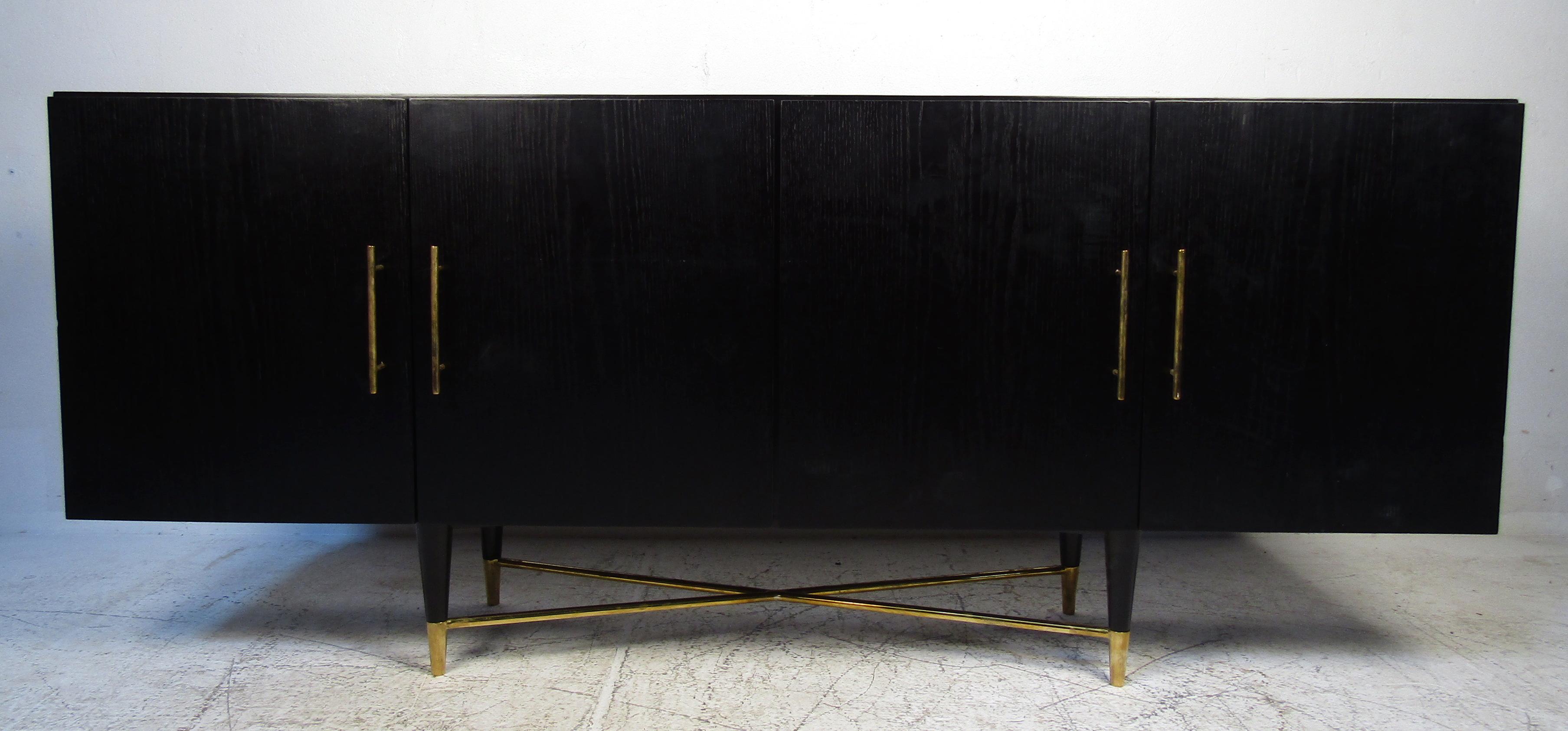 Ebonized Mid-Century Modern Italian credenza featuring brass finished pulls and sturdy tapered legs.

Please confirm the item location (NY or NJ).
   