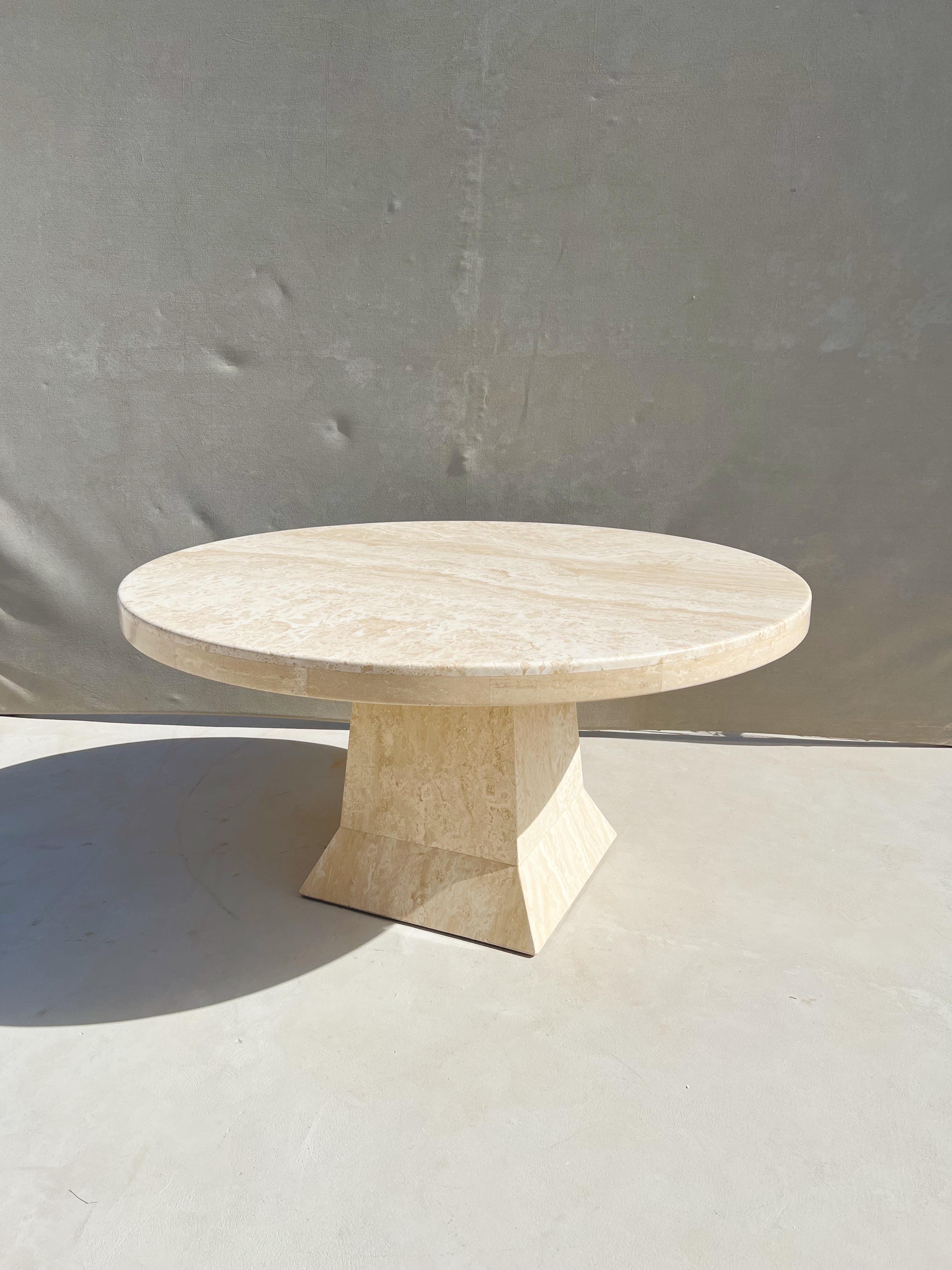 Vintage Modern Italian Travertine round dining table with a sculptural base

An exquisite and monumental Italian travertine round dining table, showcasing a light colored, glowing travertine and a strong sculptural pedestal base

This Italian