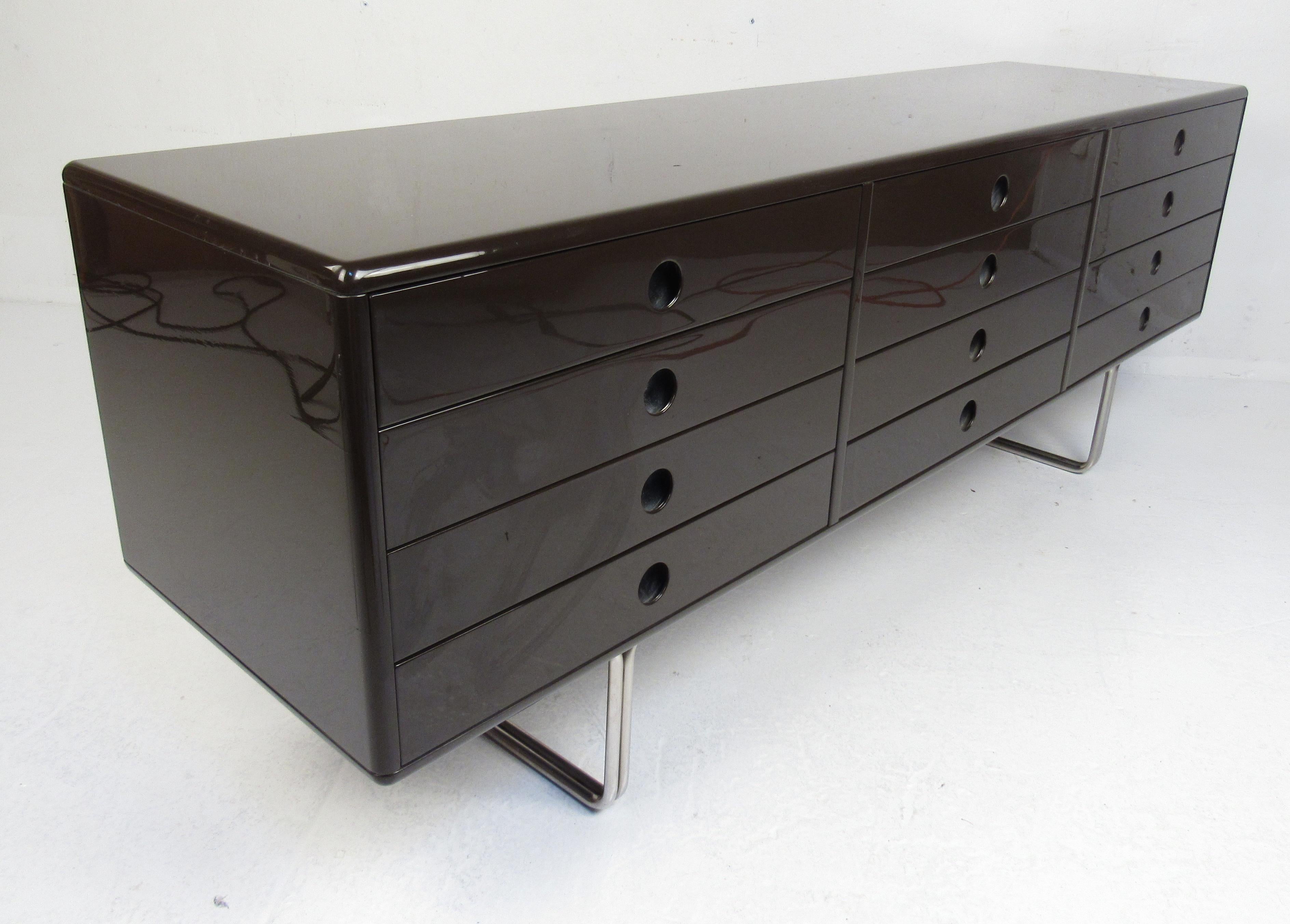 Stylish brown lacquer twelve-drawer dresser with sleek Italian modern styling, recessed drawer pulls, and chrome legs. Please confirm item location (NY or NJ) with dealer.