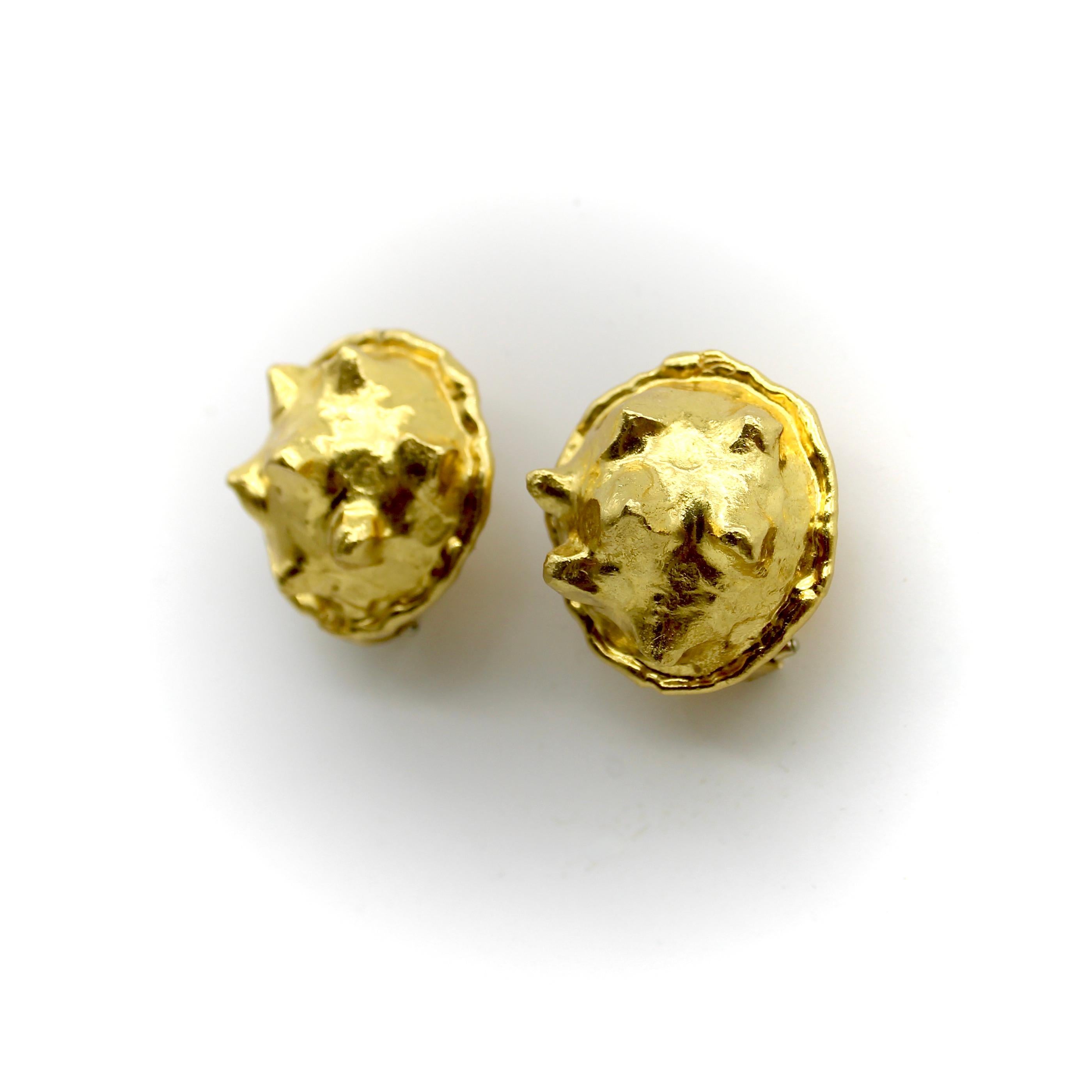 These 22k gold earrings are designed by Jean Mahie, the pseudonym for French artists Jacline and Jean Marie Mazard. The unique earrings are shaped like nodules with triangular points that extend above the domed surface of the gold. Reminiscent of
