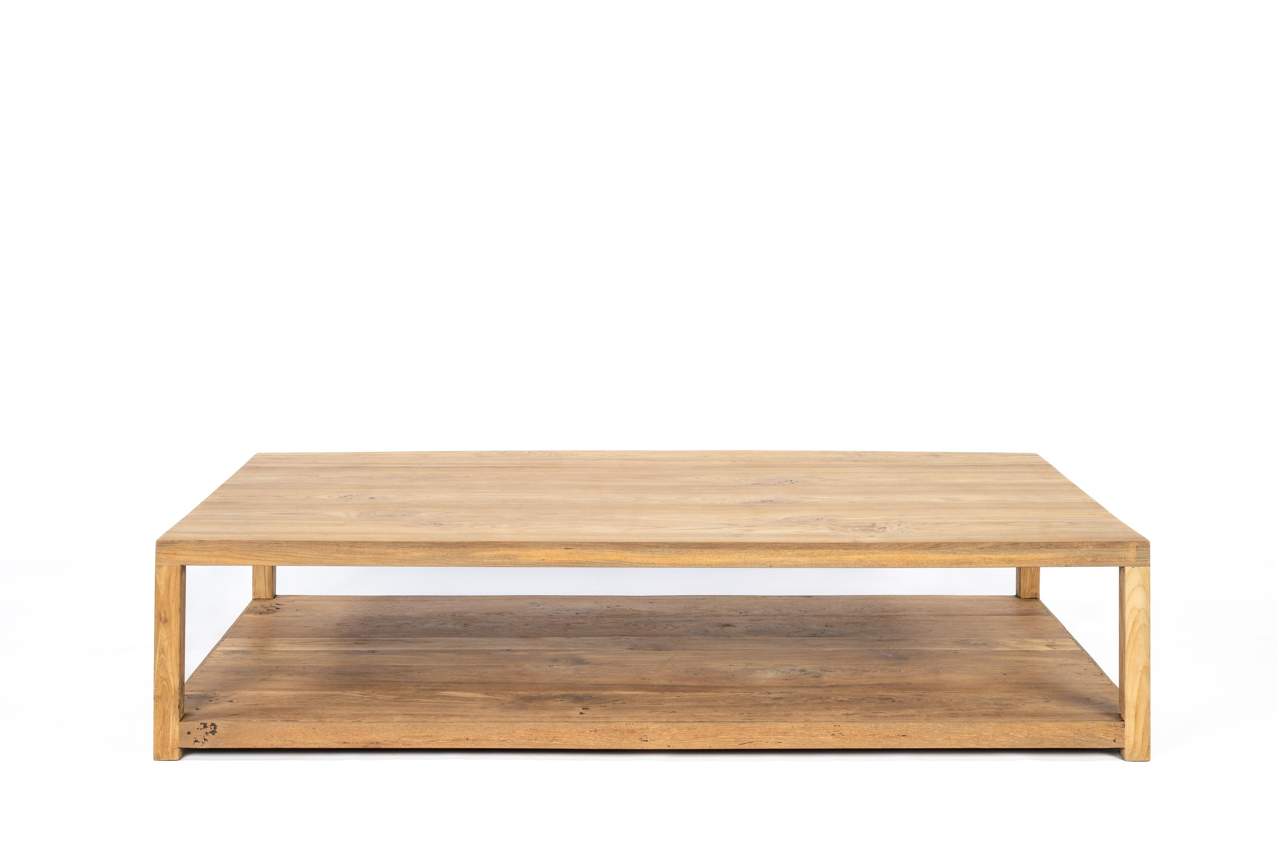 Here offered is a beautiful, sleek, modern-designed coffee table made from reclaimed teak wood. The coffee table was crafted from old teak wood sourced from old tables from Indonesia. The design of the coffee table is very sleek with a thickened
