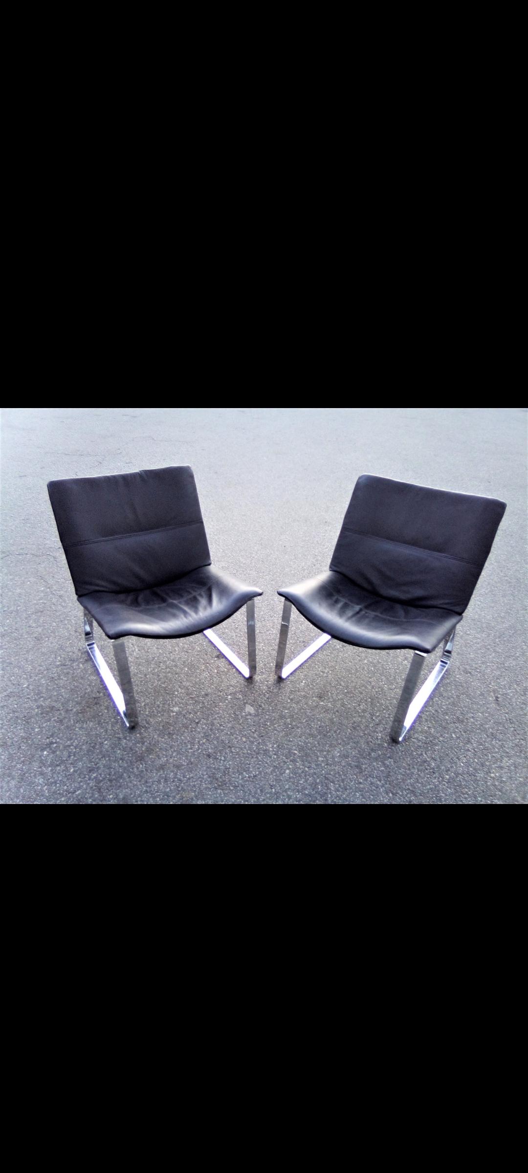 Pair of heavy steel and leather BoConcept arm chairs. Finely detailed with sturdy steel base.