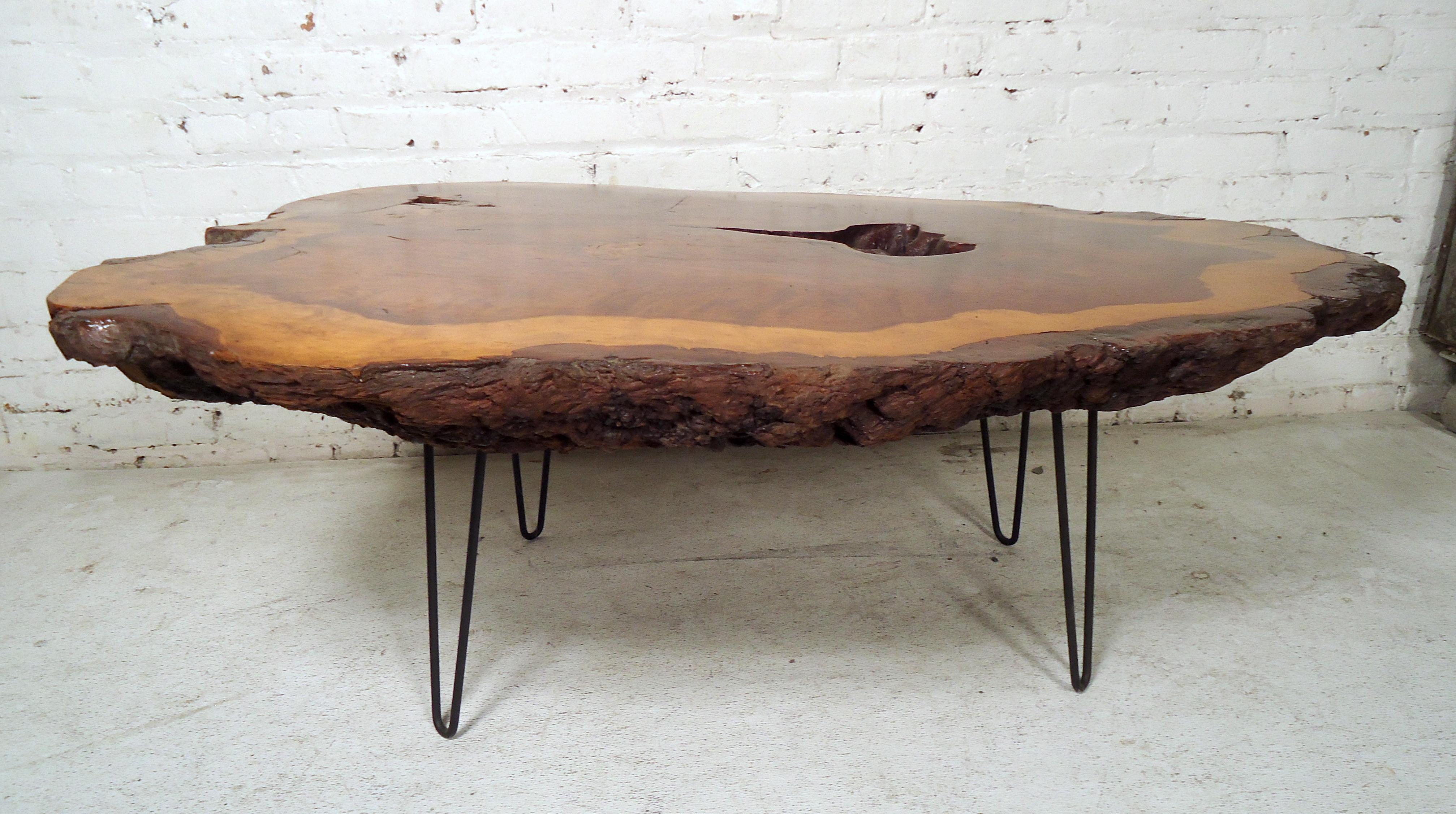 This beautiful vintage modern coffee table feature a unique tree slab top with elegant wood grain. Stylish design with iron hairpin legs ensuring maximum sturdiness. This stunning live edge table offers a taste of nature within any modern interior.