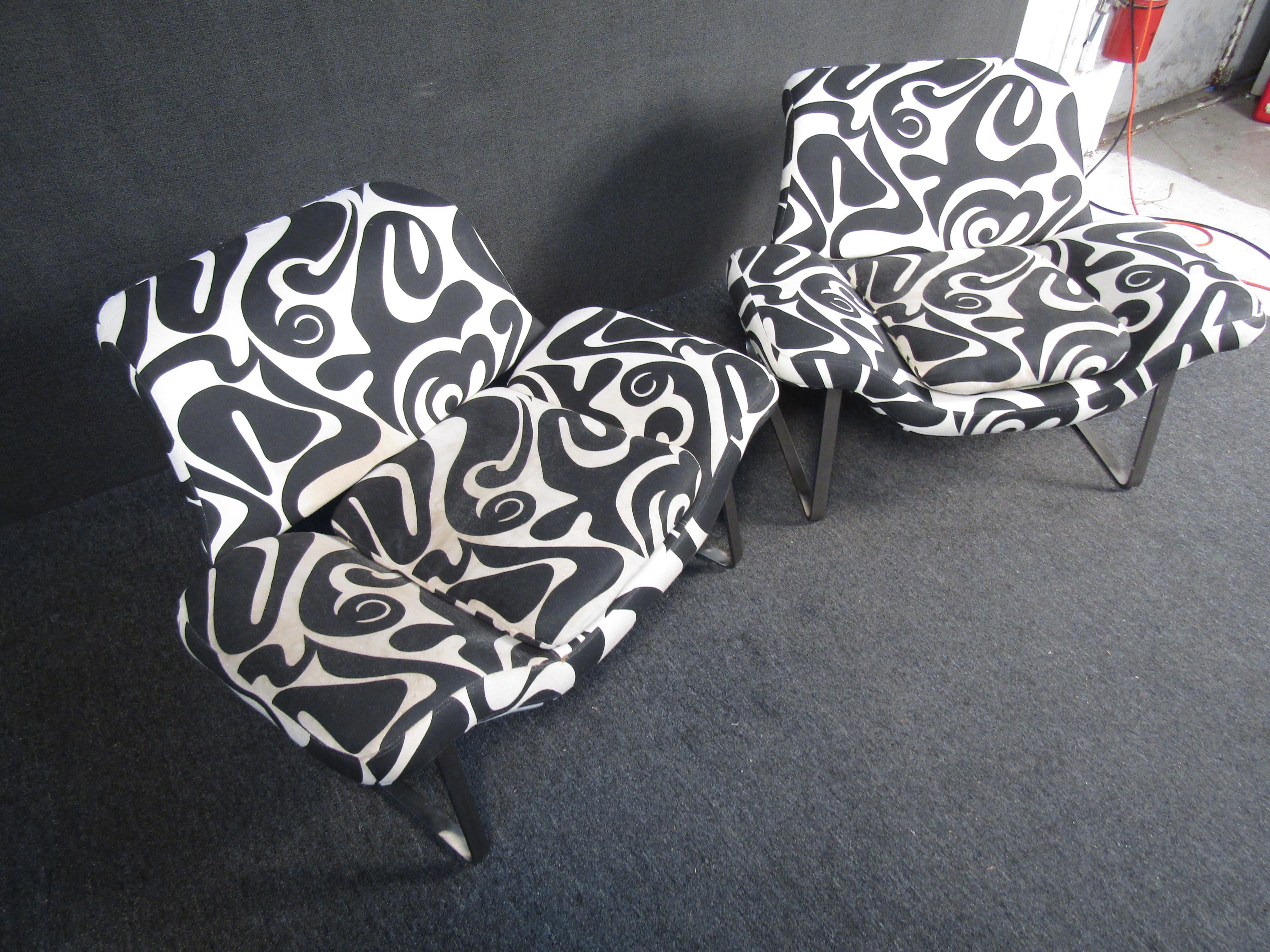Pair of vintage modern lounge chairs. These chairs feature a unique black and white fabric design as well as sturdy metal legs. The tulip style appearance would add pop to any living room or studio space.

Please confirm item location (NY or NJ).