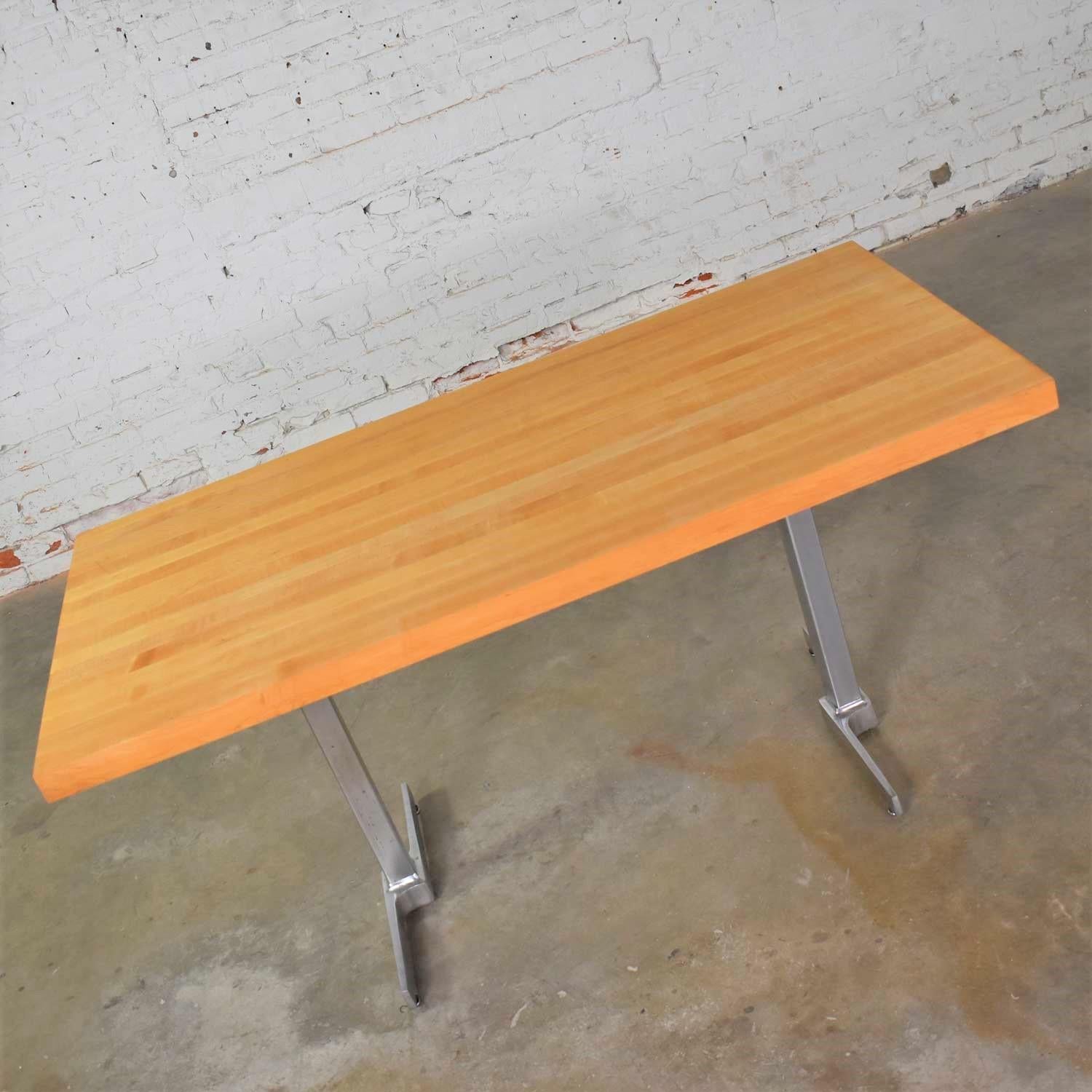 Handsome modern or maybe Mid-Century Modern dining table or worktable with a natural solid maple butcherblock style top on a pair of polished steel legs. It is in wonderful vintage condition but not without signs of age. The top has been restored