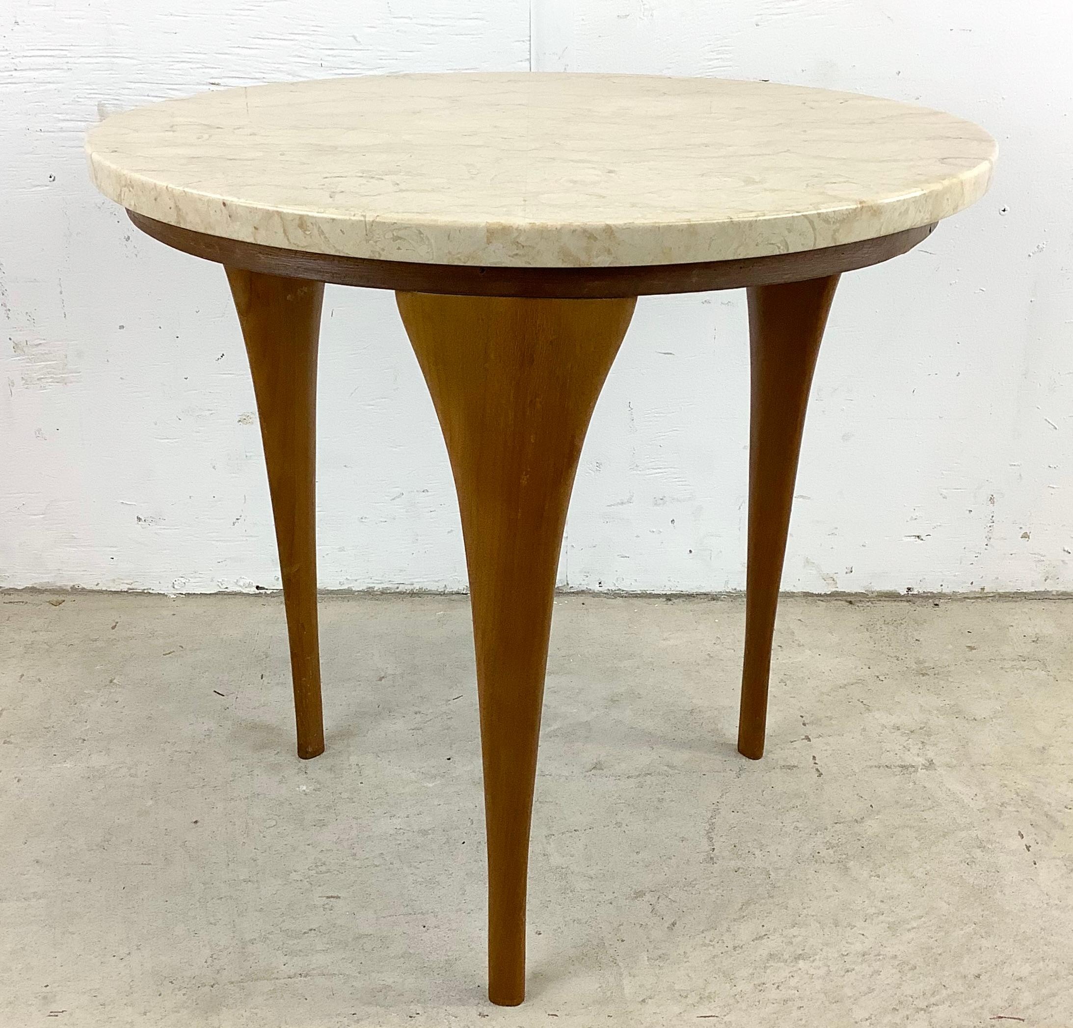 This unique midcentury oval side table features a vintage marble top, tapered sculptural wood legs, and unique Italian modern design. The simple yet styllish design of this elegant mcm end table makes this the perfect addition to any interior in