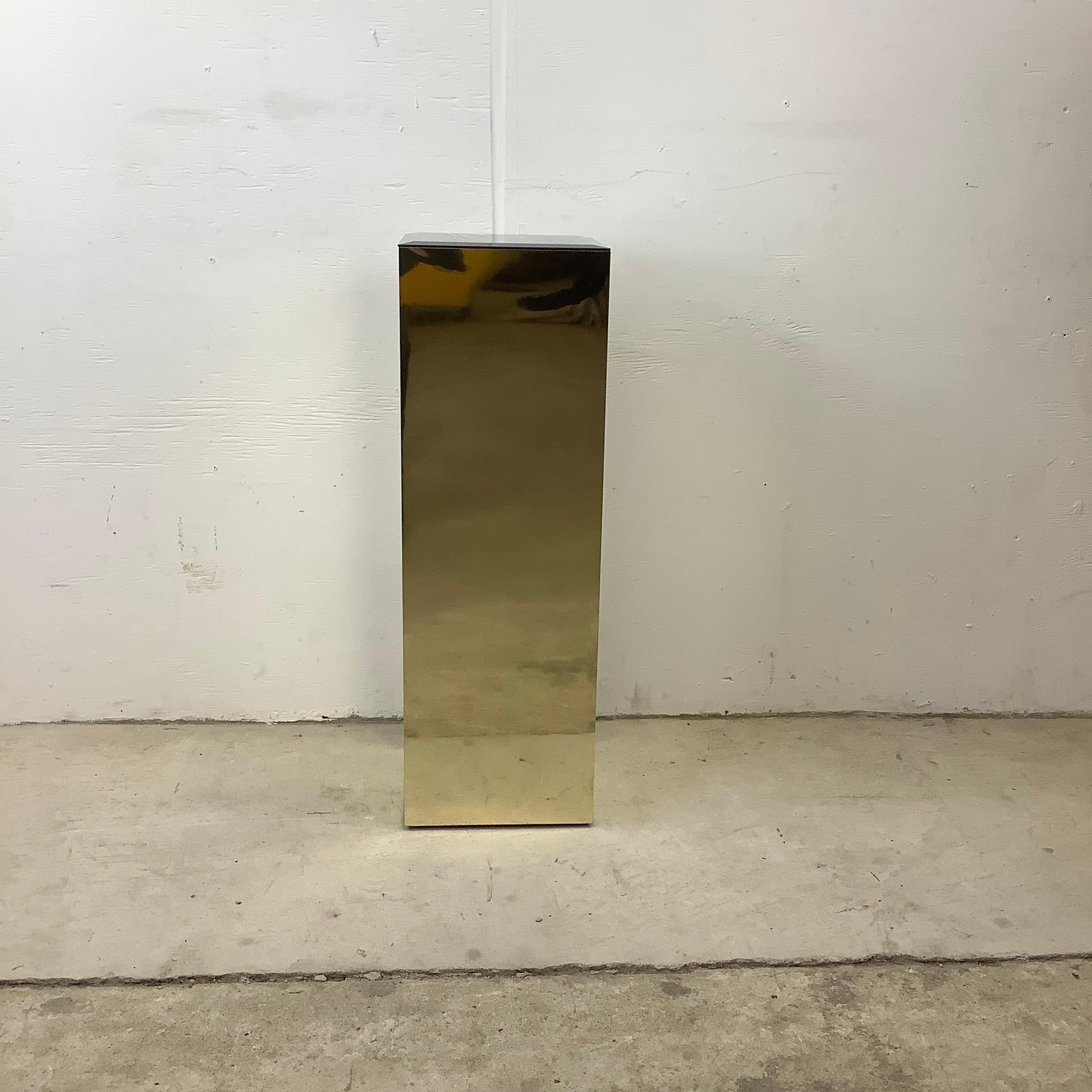 Elegant modern display pedestal features a brass tone mirrored finish with a beveled glass mirror top. This unique accent piece stands 30+ inches tall and is perfect for a sculpture display, plant stand, or otherwise. Similar pedestal pieces