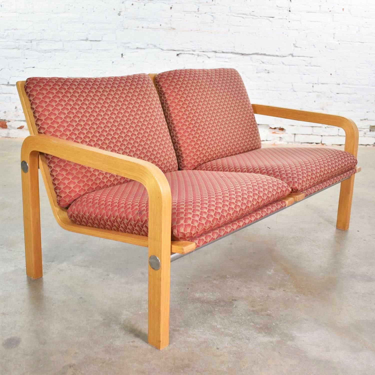 Handsome vintage modern two-seat settee or bench of oak bentwood, chrome, and upholstery attributed to Thonet. It is in wonderful vintage condition. The wood, chrome, and fabric are in ready to use condition although the fabric may not be the most