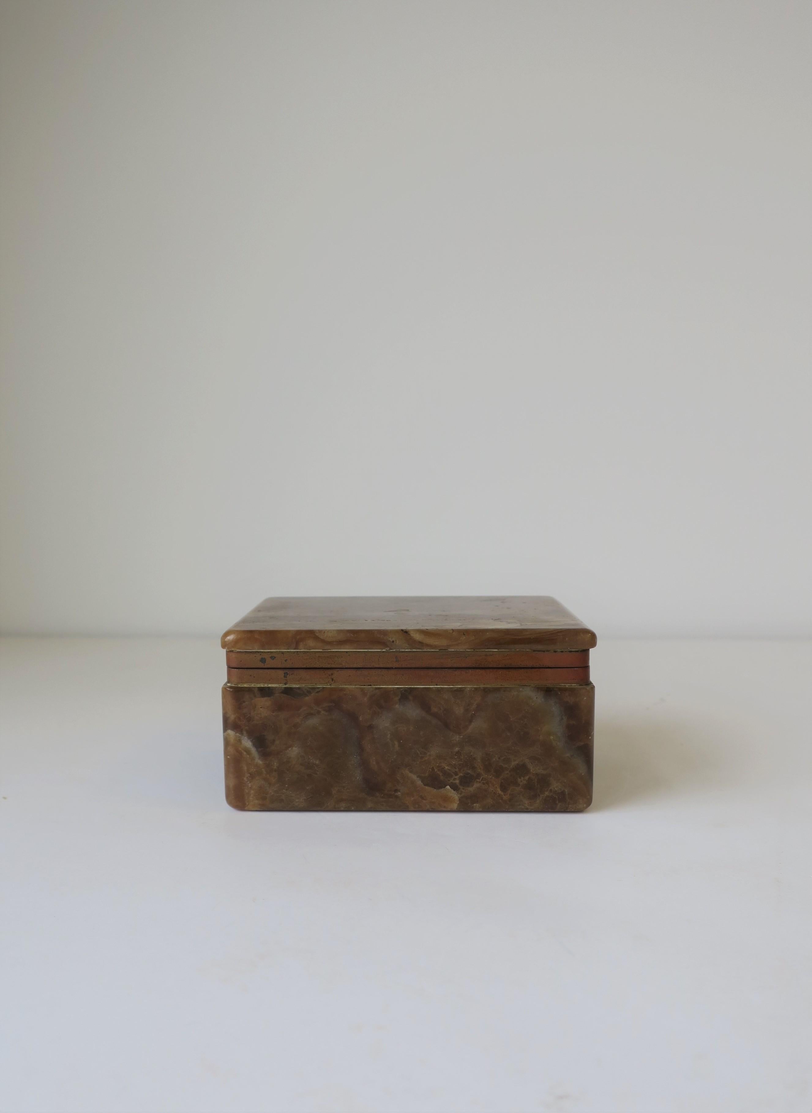 A very beautiful, substantial Belgian modern brown, caramel, and white onyx marble and brass hinged box, circa early to mid-20th century, Belgium. Box is rectangular in shape and can hold jewelry (as demonstrated) or other small items on a desk,