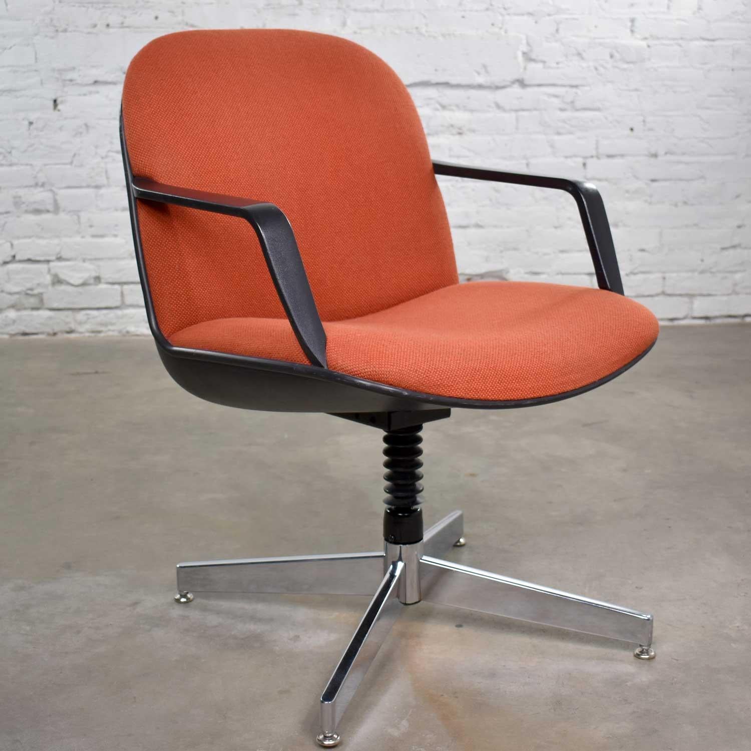Handsome orange hopsack fabric covered armchair with adjustable height in the style of the Charles Pollock chair for Knoll. It is in wonderful vintage condition with no outstanding flaws and only normal wear for its age. Please see photos. Circa