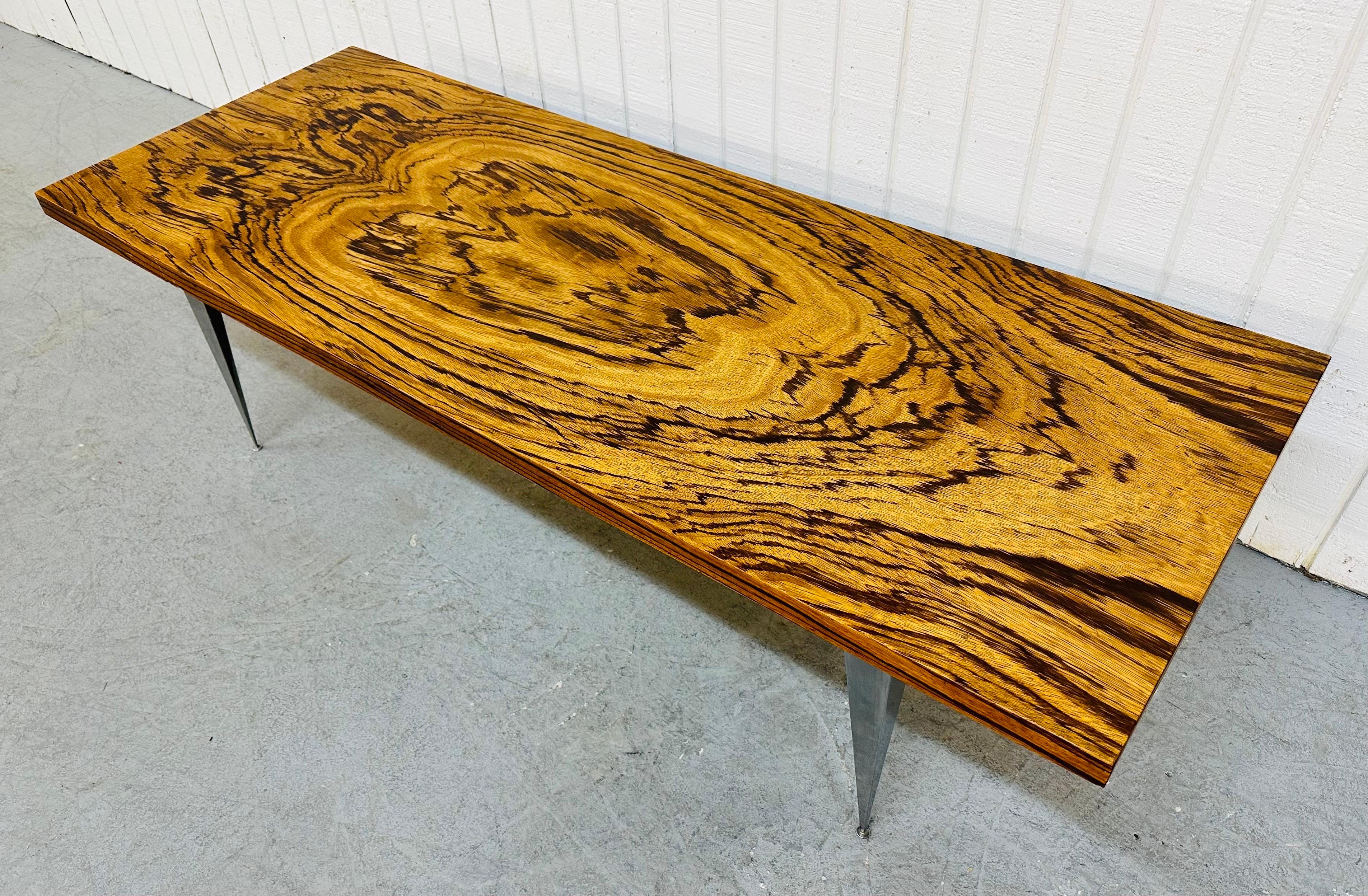 This listing is for a Vintage Modern Rosewood coffee table. Featuring a rectangular rosewood top and four chrome angular legs.