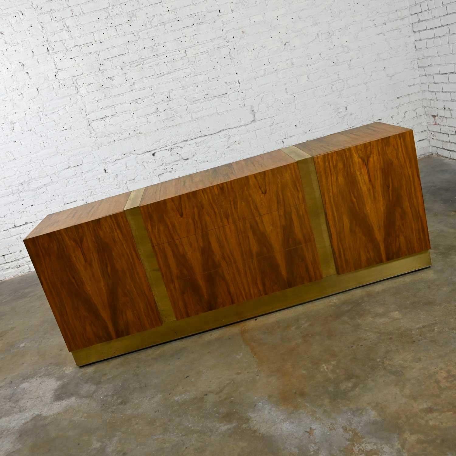 Stunning vintage modern dresser, credenza, or buffet by Milo Baughman for Thayer Coggin. Comprised of gorgeous rosewood veneer and brass plated steel bands. Three center drawers and two side doors with three ebonized pull-out shelves each side.