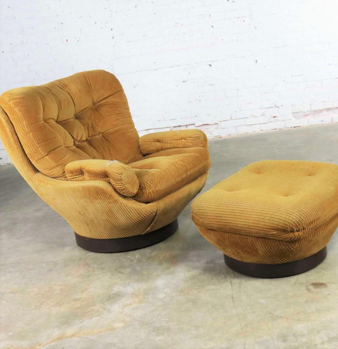 Handsome and comfortable vintage modern overstuffed swivel chair and ottoman by Selig. Done in the style of the Elda chair by Joe Columbo but an icon of its own. Selig tag under seat cushion. This pair is structurally in fabulous condition, but the