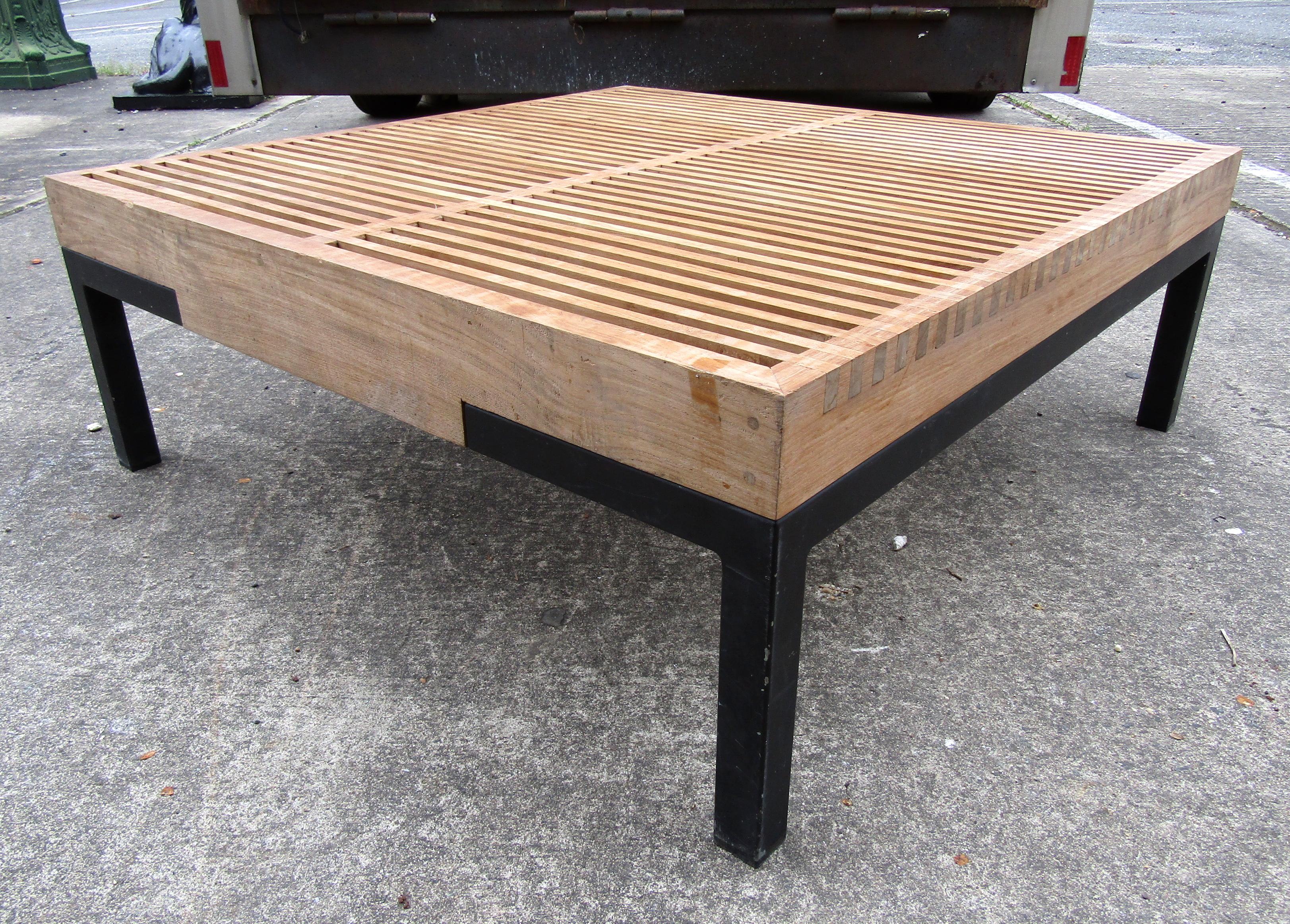 Mid-Century Modern wood slatted coffee table featured on sturdy metal legs.

Please confirm the item location (NY or NJ).