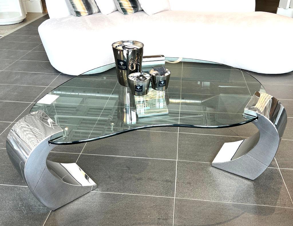 Vintage Modern stainless steel and glass coffee table. Stunning stainless steel pilar cantilever design with unique kidney shaped glass. All original in good condition. American, circa 1970’s, iconic modern styling. Price includes complimentary curb