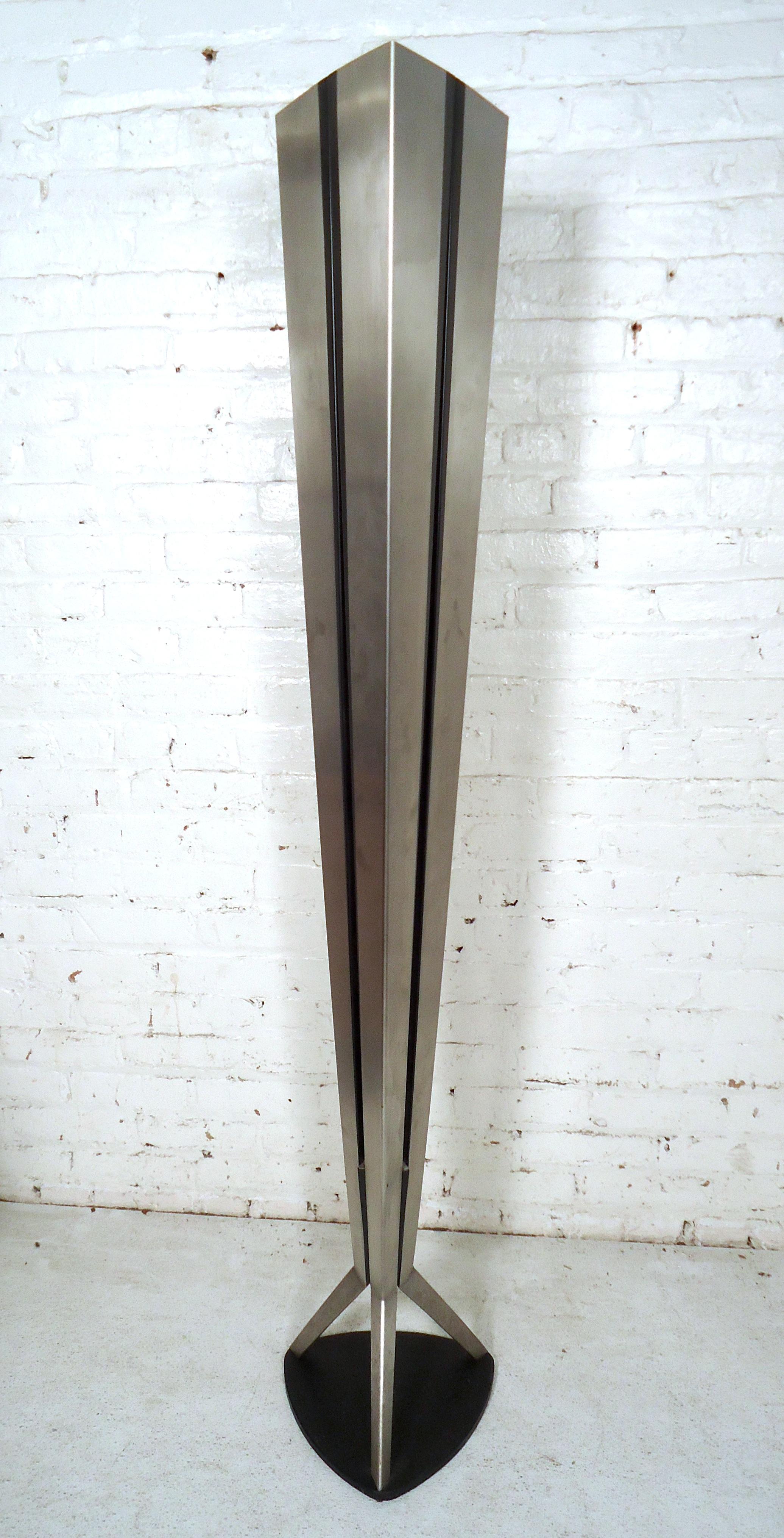 Mid-Century Modern stainless steel four bulb floor lamp featuring a sturdy tripod base.

Please confirm item location (NY or NJ) with dealer.
