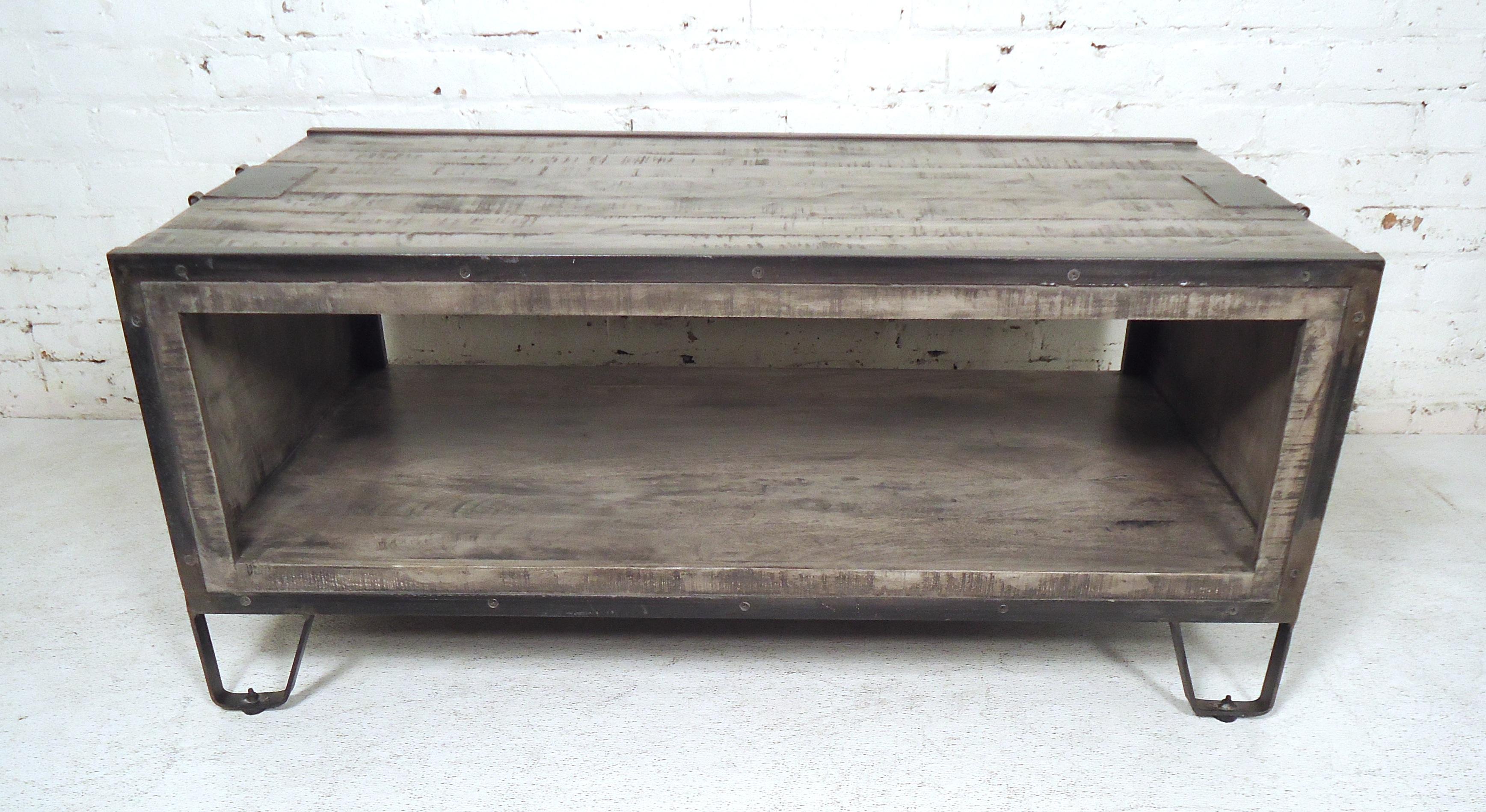 Machine aged style coffee table featuring a rustic wood design and industrial frame.

(Please confirm item location - NY or NJ - with dealer)
    