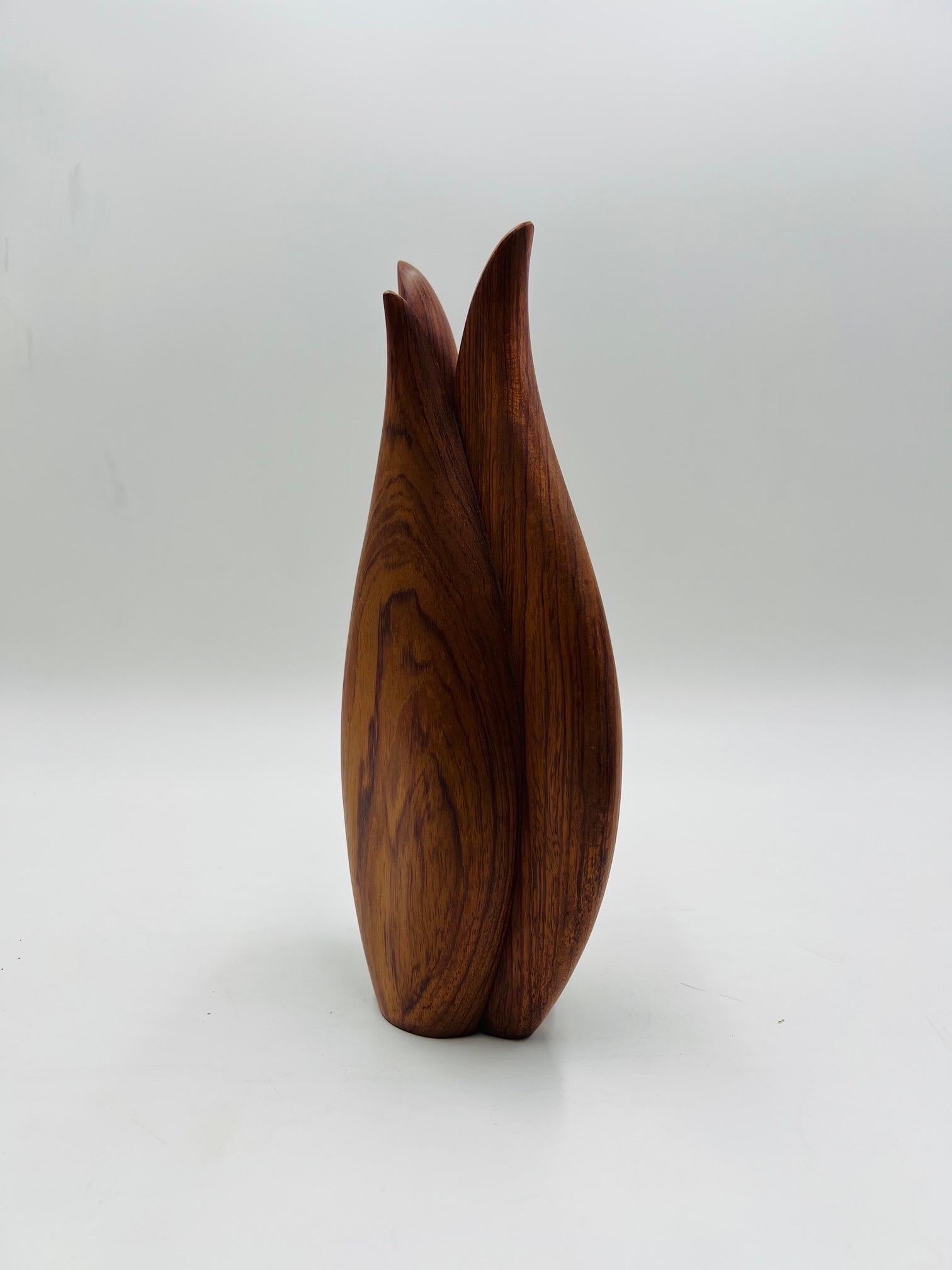 Vintage modern style studio quality vase featured in teak wood. Shows beautifully in a modern or traditional setting.