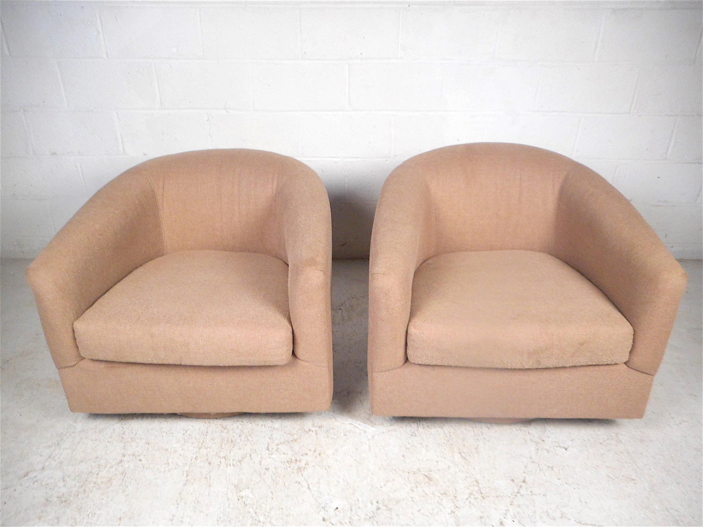 Stylish pair of midcentury lounge chairs on swiveling bases. Spacious seating area with soft cushioning, circa 1980s. Great pair of chairs sure to make an impression in any modern interior. Please confirm item location with dealer (NJ or NY).
