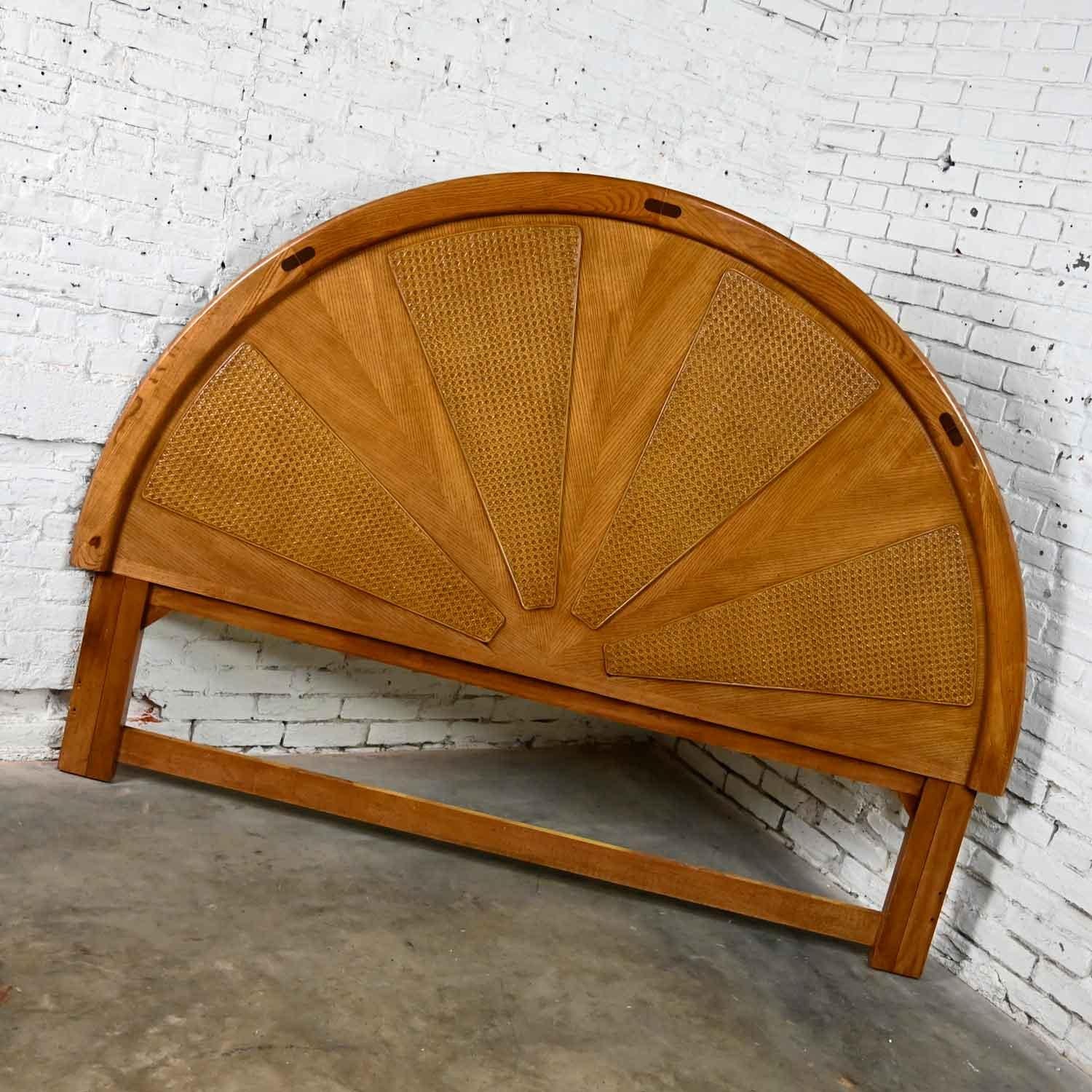 Wonderful vintage modern to postmodern arched rising sun pattered oak and cane king sized headboard. Beautiful condition, keeping in mind that this is vintage and not new so will have signs of use and wear. Several scratches on the arched outer