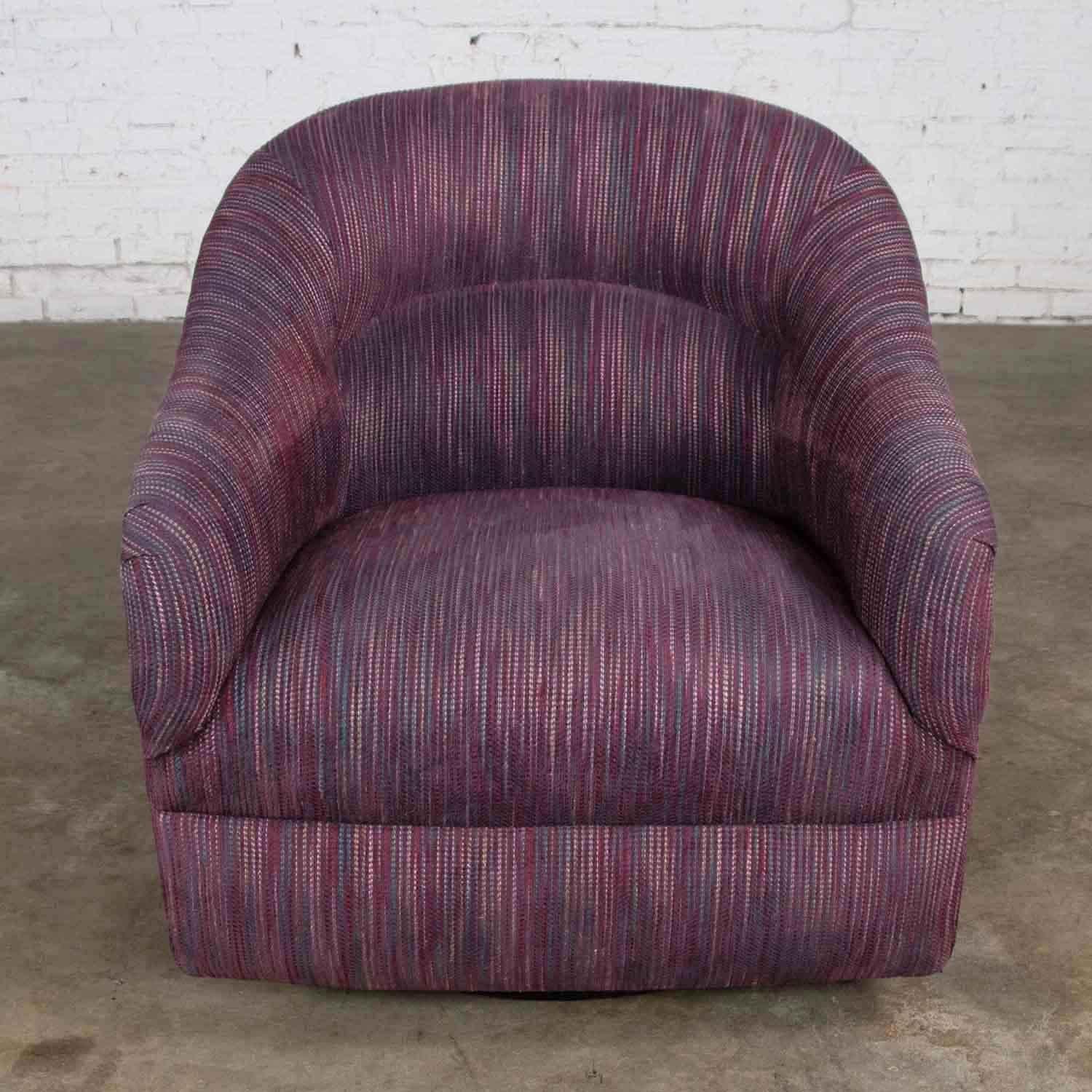 Handsome modern swivel rocking tub chair in aubergine or eggplant purple upholstery fabric. It is in wonderful vintage condition. There is a slight fading to the fabric but because of its variegated coloration is it hard to distinguish. Please see