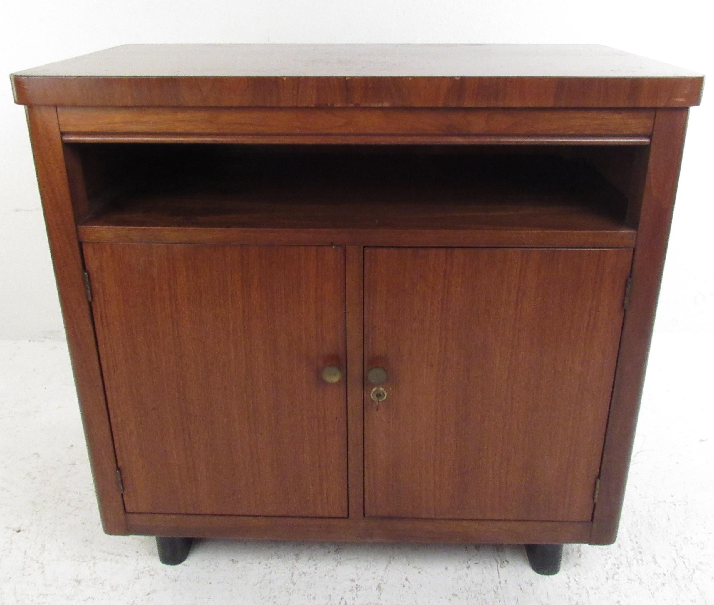 A Mid-Century Modern walnut cabinet boasting ample storage and sleek design. Perfect for any home/office setting. Please confirm pickup location (NY/NJ).