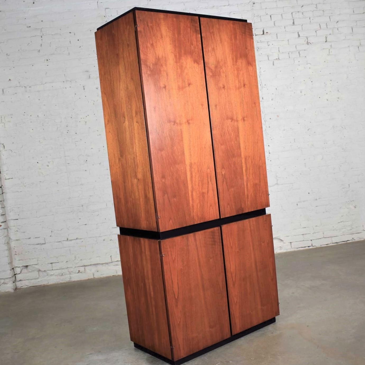 Handsome modern or Mid-Century Modern style entertainment cabinet or storage armoire in walnut with black accents by the Barzilay Furniture Mfg. Company. It is in fabulous vintage condition with no outstanding flaws we have found. Please see photos,