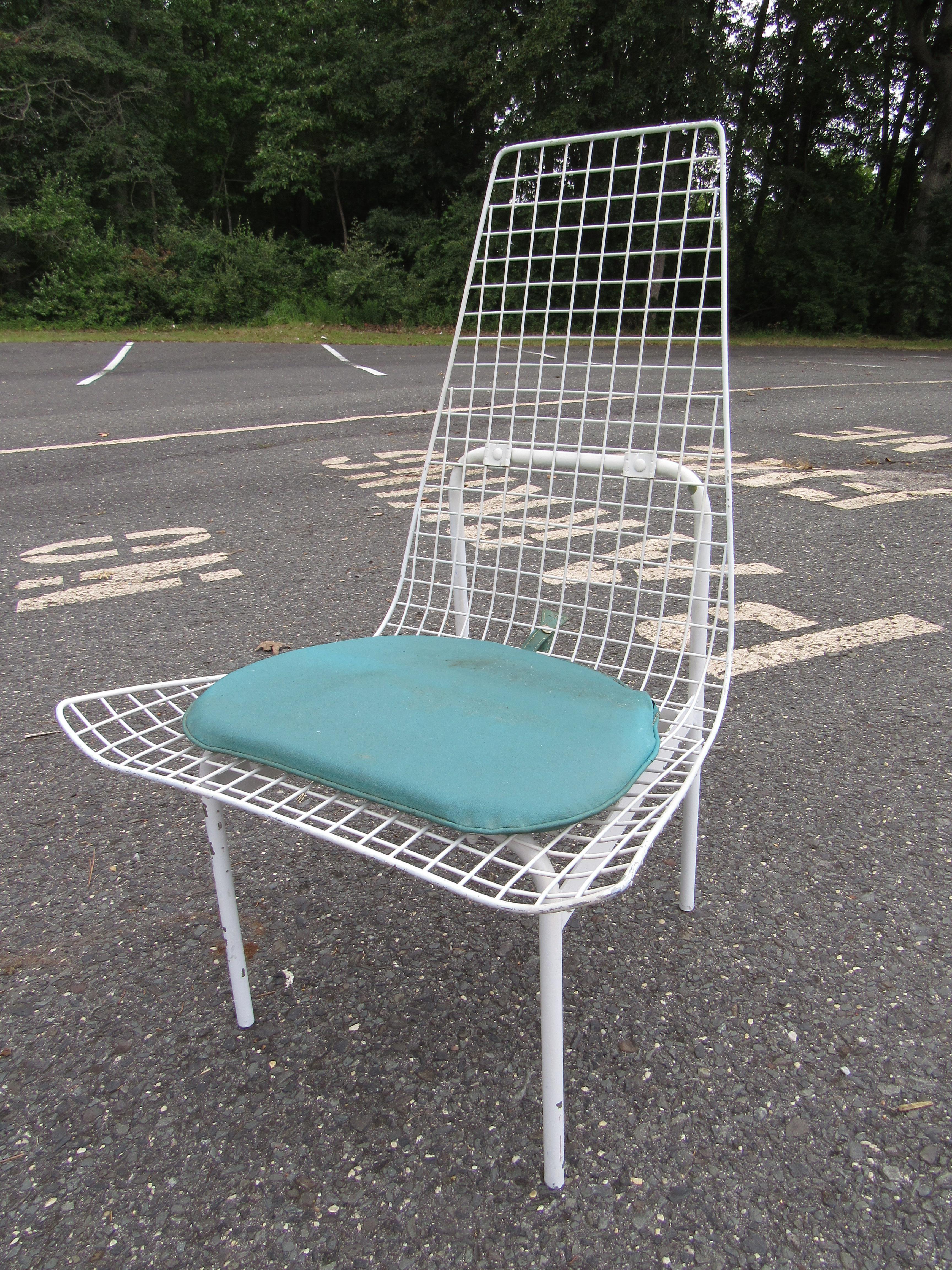 Unusual set of 4 vintage modern patio chairs. Spacious seats with high backs ensuring comfort. Sturdy metal constructions with wire mesh supporting the seating area. This set of chairs is sure to impress in any patio/outdoor setting. Please confirm