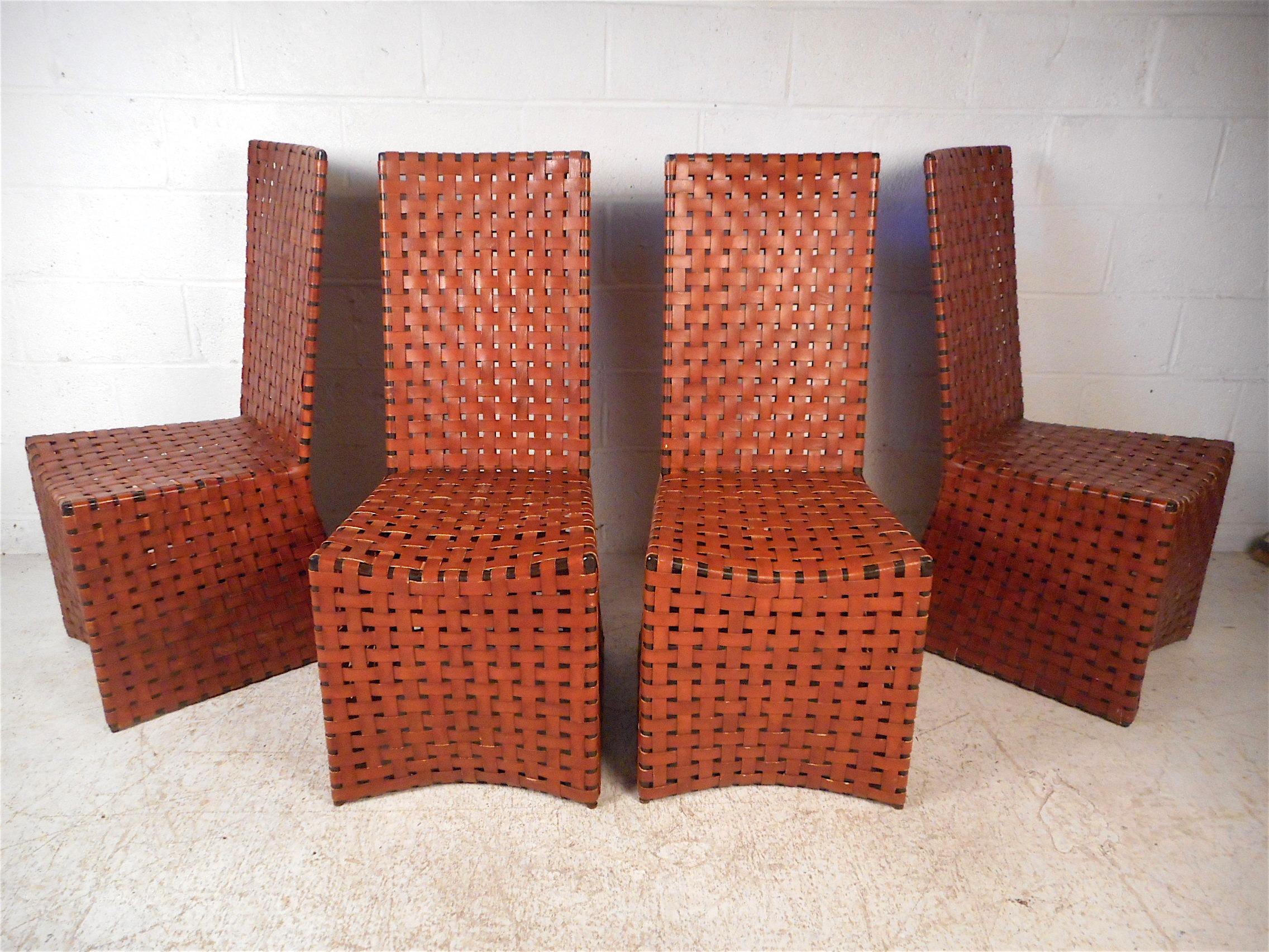 Unique set of 4 vintage modern chairs with a woven leather upholstery and a sturdy metal frame beneath. Tall backs and spacious seats ensure comfort and style. This set of unusual chairs is sure to prove a great addition to any home, business, or