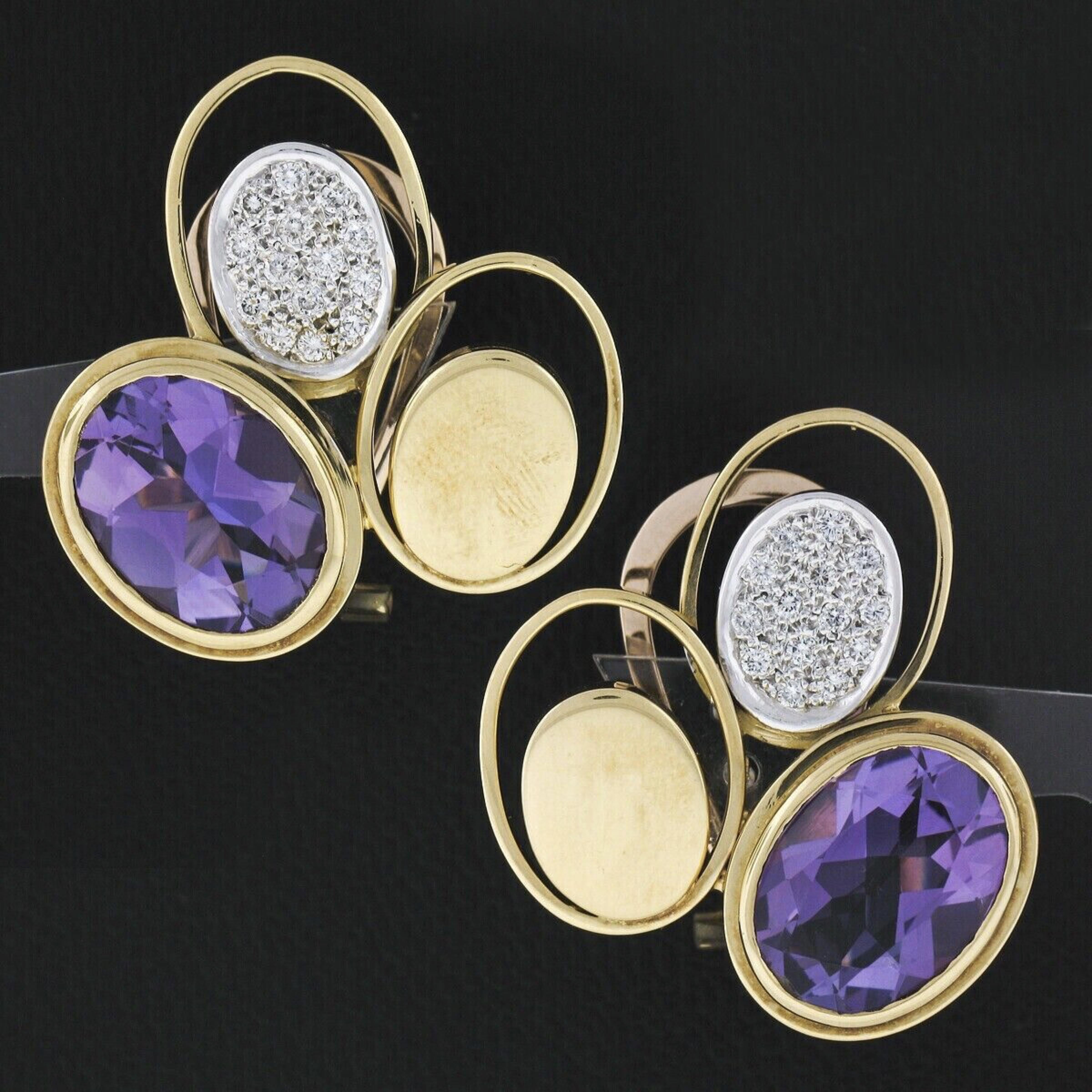 This magnificent, very well made pair of vintage earrings was crafted from solid 18k gold and features a pair of oval brilliant amethyst stones weighing approximately 13 full carats, and display a gorgeous, rich and subtle royal purple color. The
