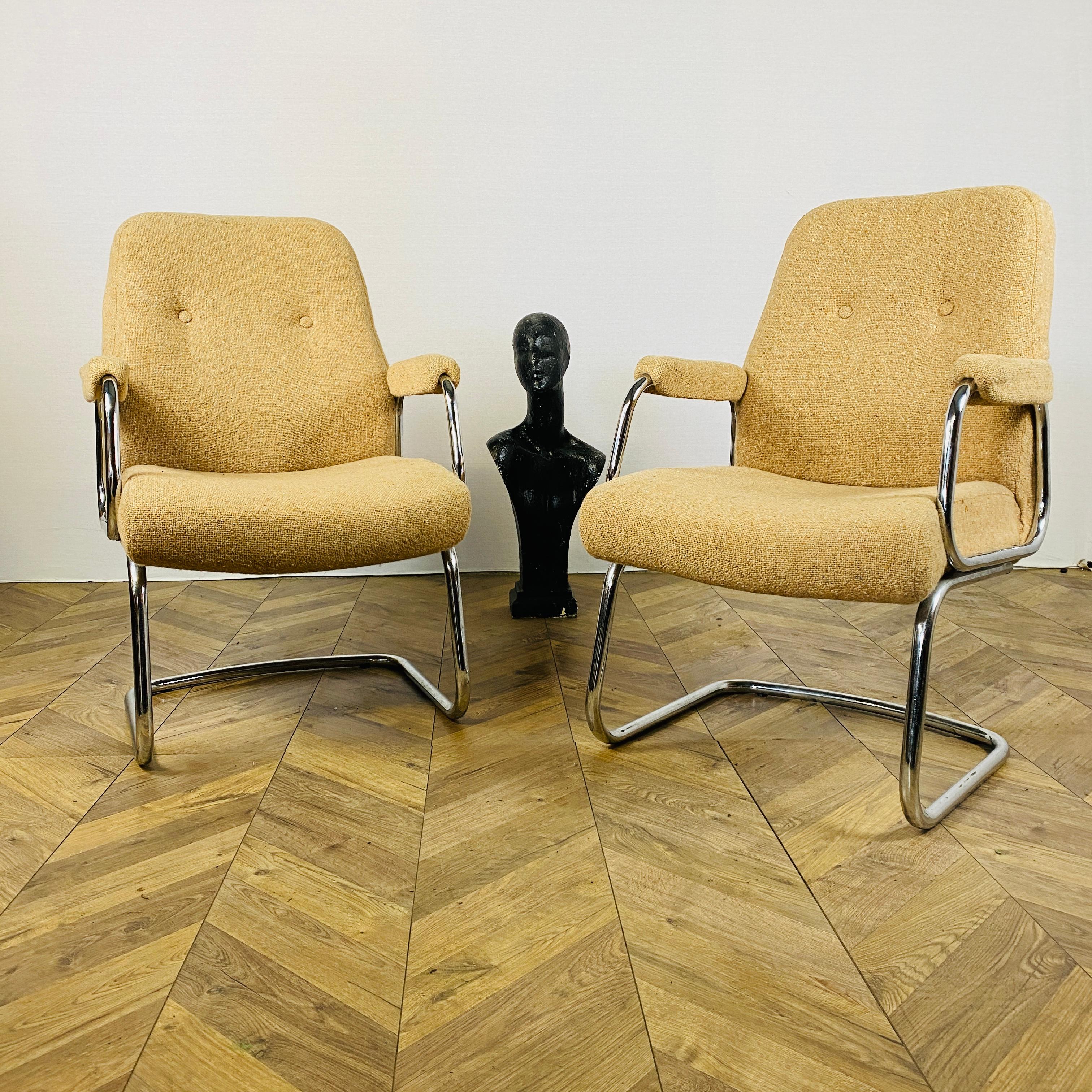 A pair of mid-century, Modernist armchairs made in England by Renowned Manufacturers; Evertaut International.

Boasting clean lines and in good vintage condition, the chairs frames are made from chrome and fabric seat & back, which provide a