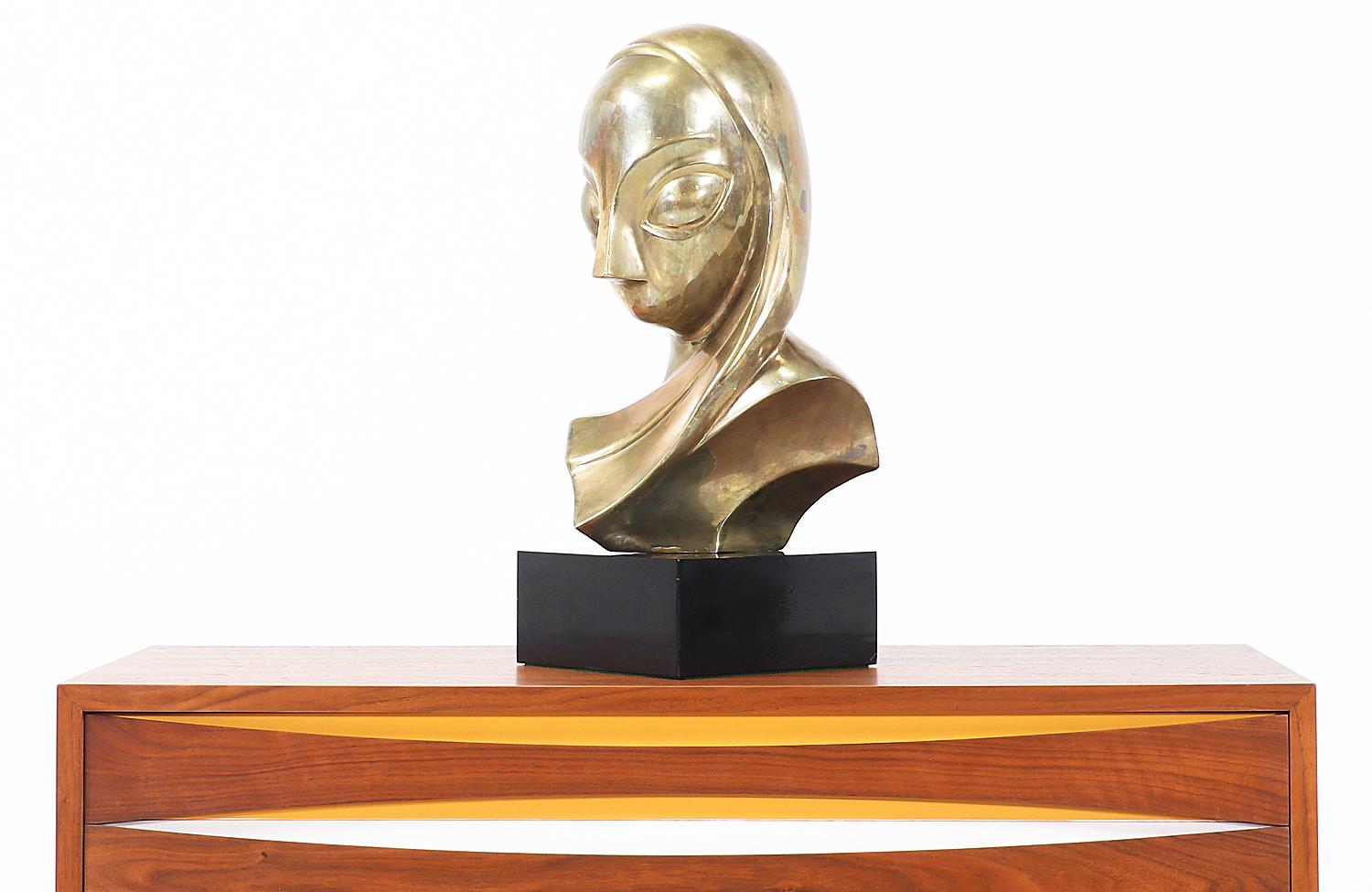 Vintage modernist bust sculpture designed and manufactured in the United States, circa 1970s. Inspired by the style of Constantin Brancusi, this sculpted woman bust is rendered in brass and mounted on a black base, creating a uniquely beautiful
