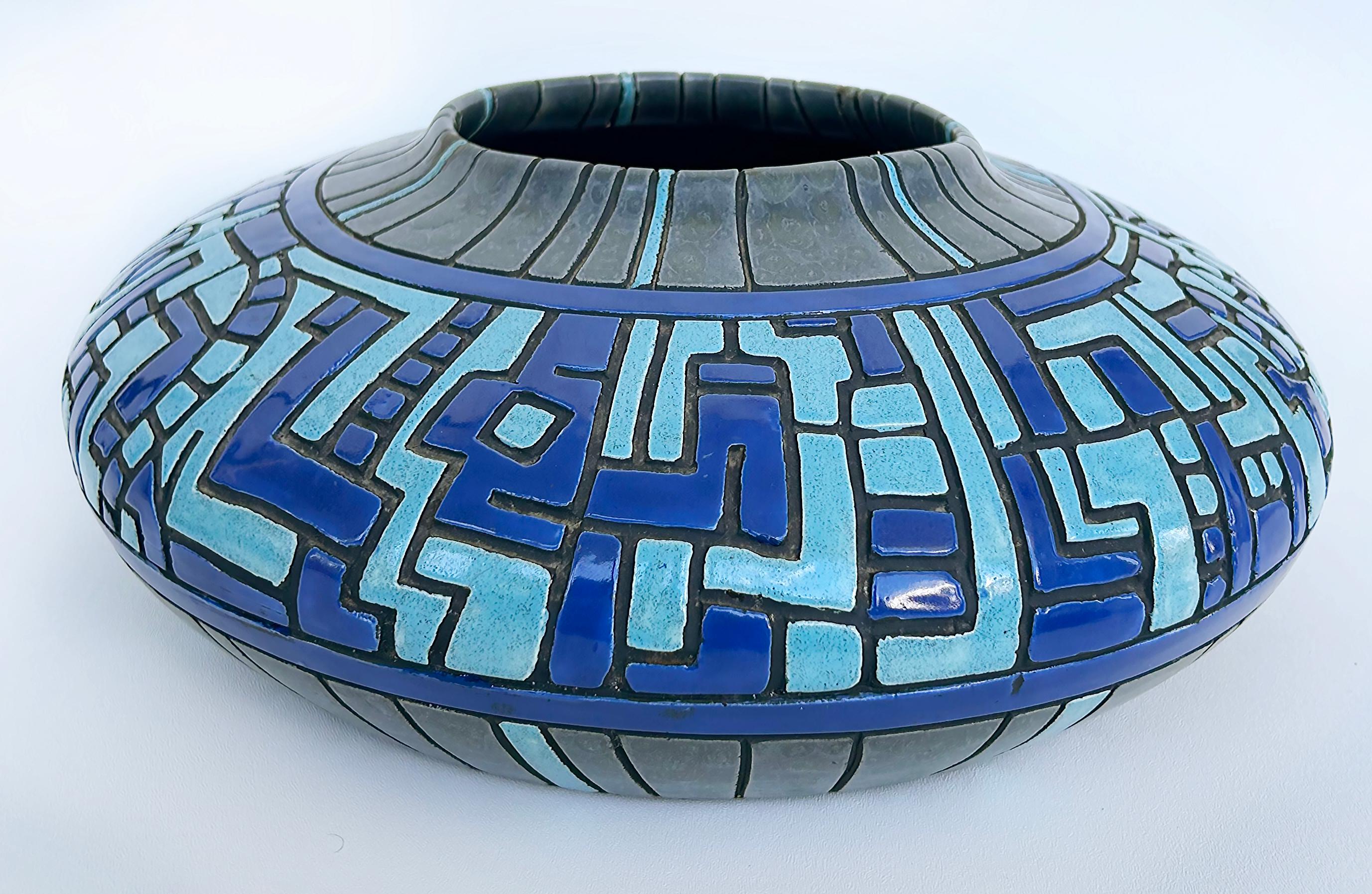 Vintage Modernist Ceramic Centerpiece Geometric Bowl, Signed 

Offered for sale is a large ceramic centerpiece bowl with glazed patterns and incised borders. The blow is gray, blue, and turquoise. The base is signed as shown and the modernist feel