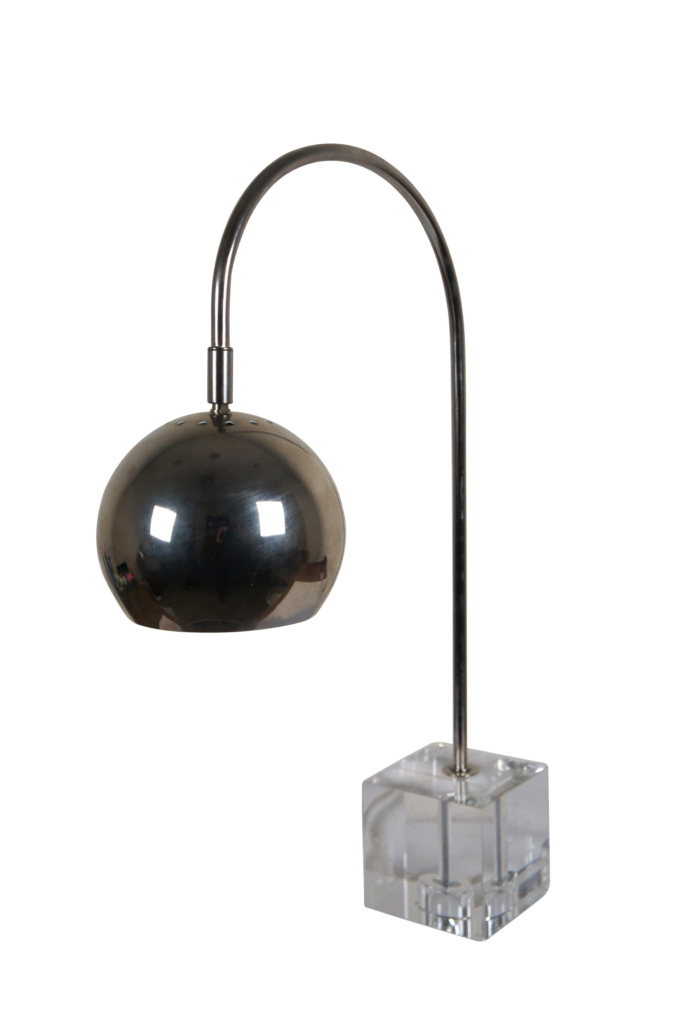 Late 20th century mid century modern style / atomic / modernist desk / table lamp featuring a cubic lucite base supporting a chrome stem arching to an orb / eyeball shaped shade.

Dimensions:
15.75