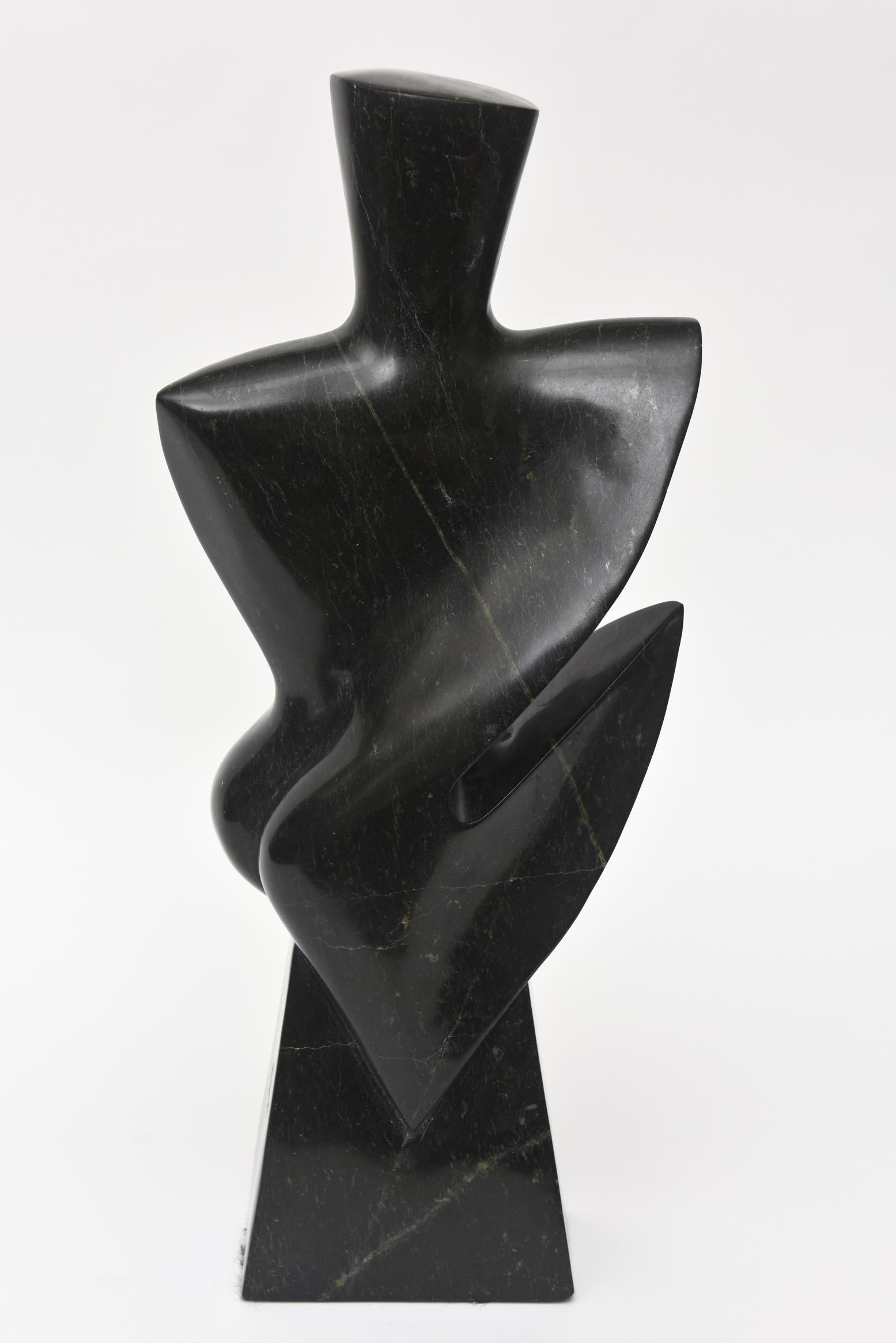 This amazing vintage modernist heavy granite sculpture has cubist forms. The granite has veins of green running through with black. It is from the 1980s and from every angle it changes its pose. It is dynamic, present and fabulous! It is headless