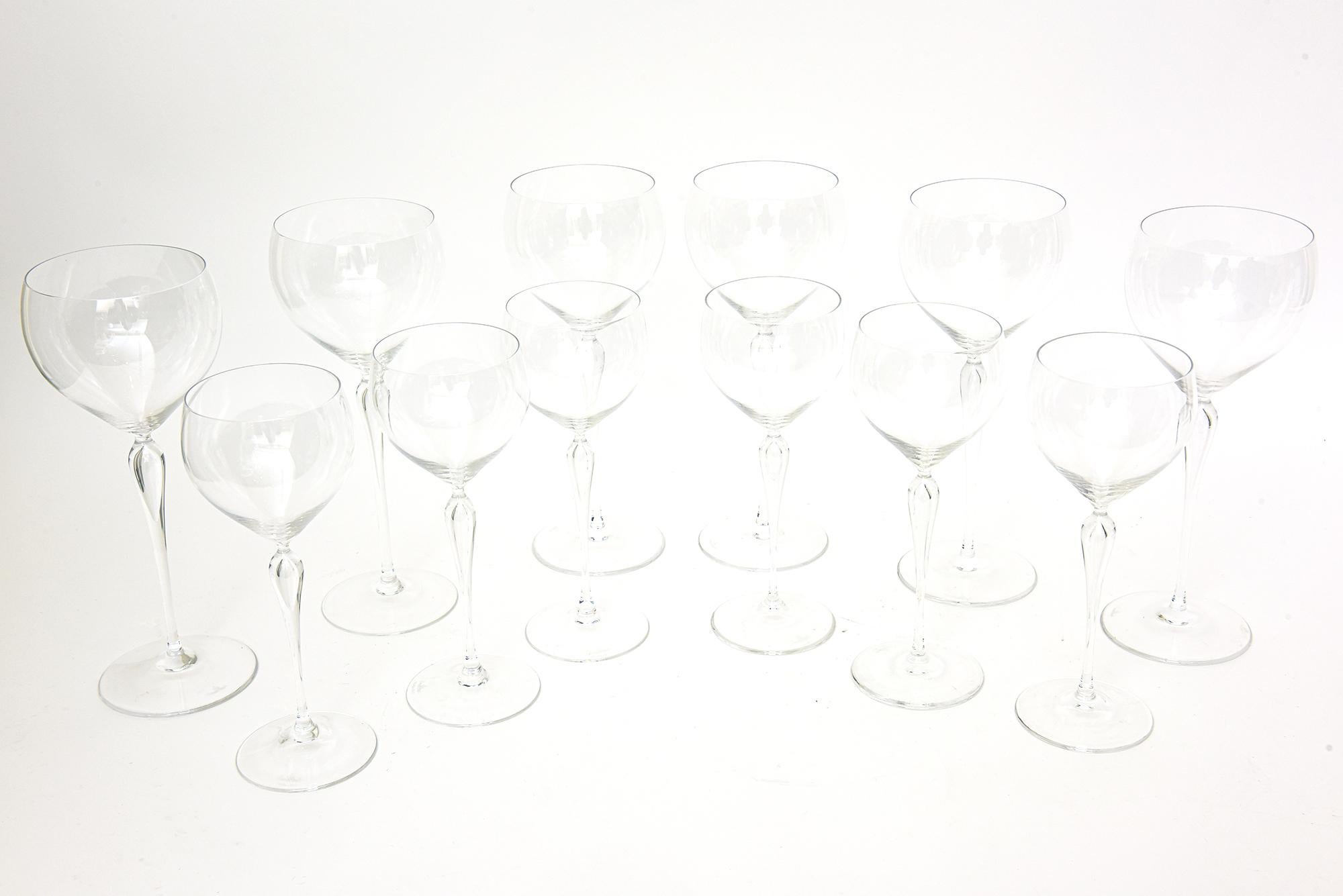 This elegant, modernist and vintage Rosenthal set of 24 hand blown lead crystal white wine and red wine glasses are made in Germany and from the 80's. It is called the Maitre pattern and rings with simplicity, refinement and modern attributes. It is