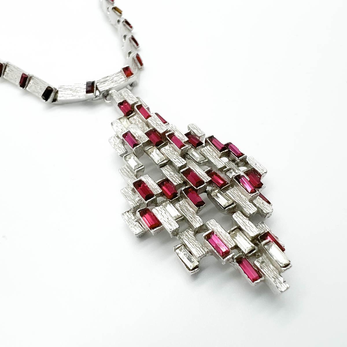 A Vintage Modernist Ruby Necklace. A stunning design embellished with wonderfully rich pink ruby baguettes delivers a timeless piece with attitude. 
An unsigned beauty. A rare treasure. Just because a jewel doesn’t carry a designer name, doesn’t