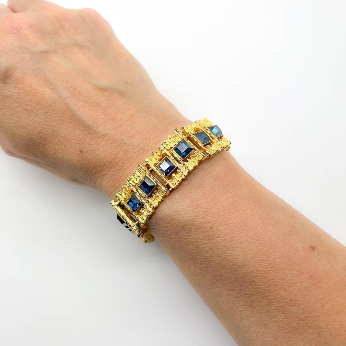 A Vintage modernist sapphire bracelet. A captivating design, no doubt inspired by the great fine jewellers of the 1960s, such as Grima, this bracelet is an eternally stylish piece of wearable art. Set with square cut sapphire crystals. Adorn your