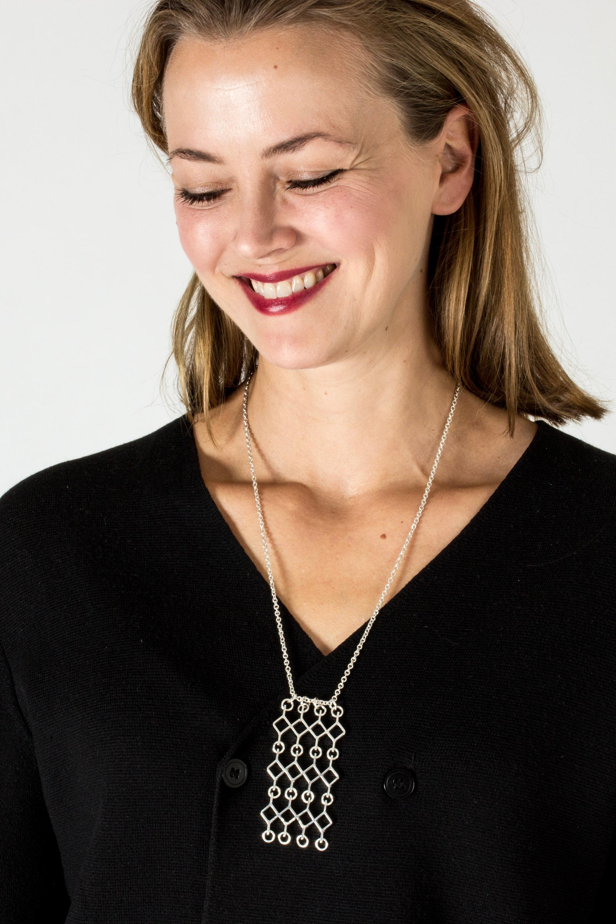 Striking silver pendant by Jorma Laine in an intricate graphic design with kinetic parts. Lovely attention to detail.