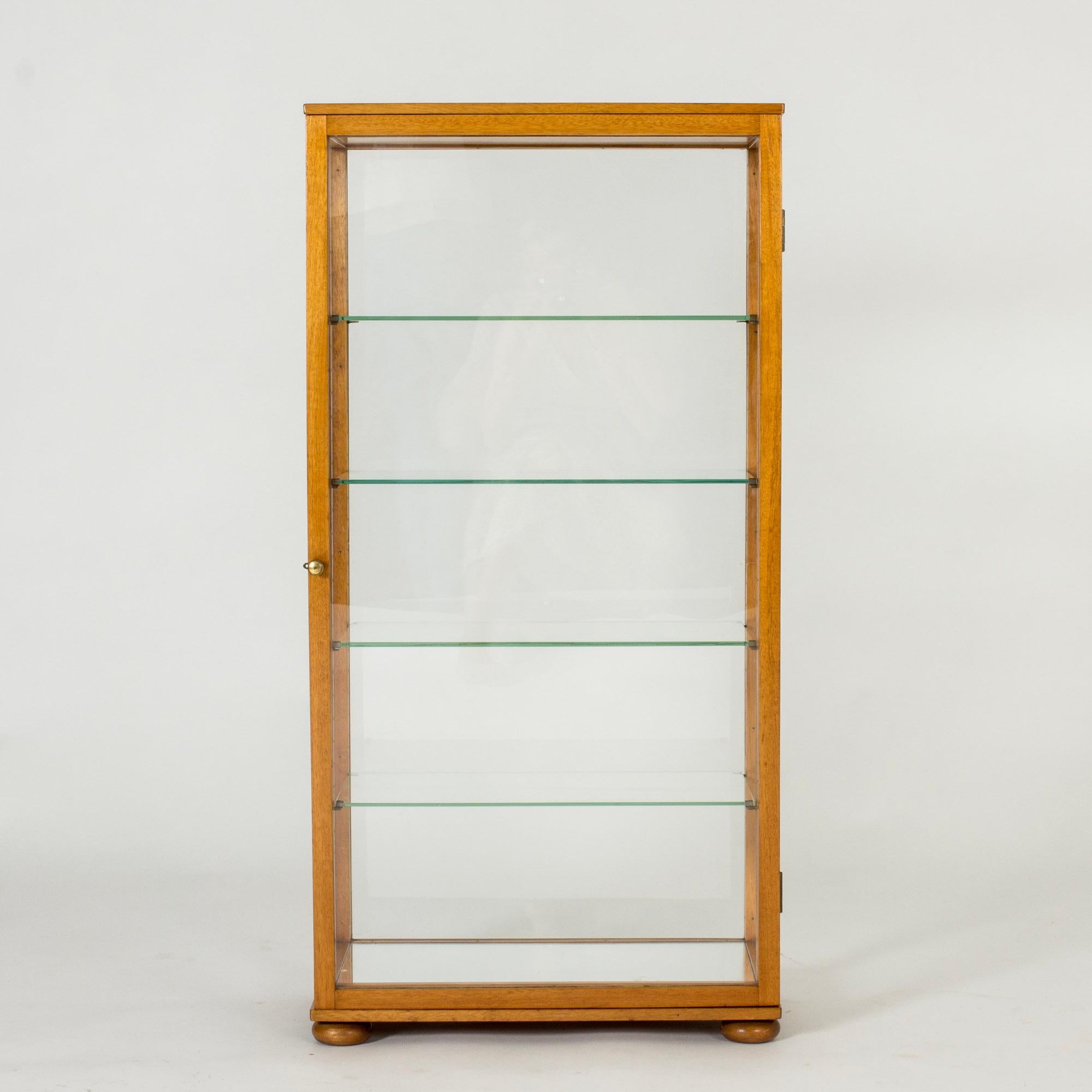 Beautiful table vitrine cabinet by Josef Frank, made from mahogany in a sleek design. Glass shelves and mirror bottom let the light flow freely. Perfect for displaying cherished objects.