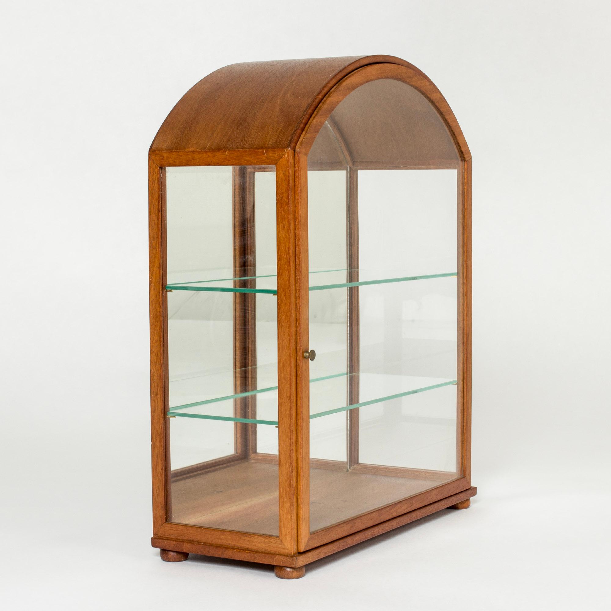 Beautiful table vitrine cabinet by Josef Frank, made from mahogany in a sleek design. Glass shelves and mirror bottom let the light flow freely. Perfect for displaying cherished objects.
