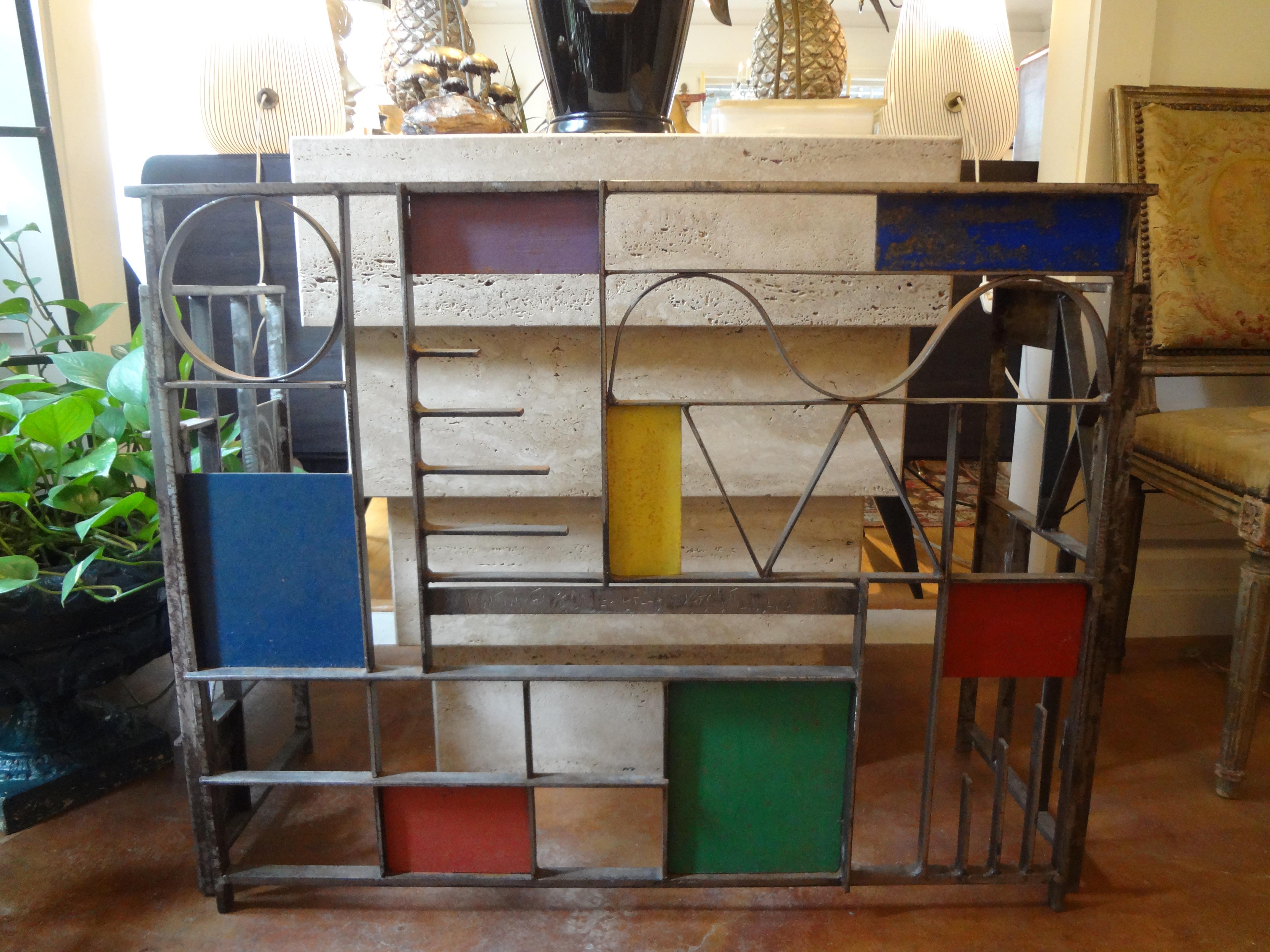 Fabulous vintage modernist or Machine Age hand forged wrought iron fireplace screen or fire screen. This beautiful artistically designed geometric fireplace screen was executed in primary colors and artist-signed, Robert Gilchrist on one of the side