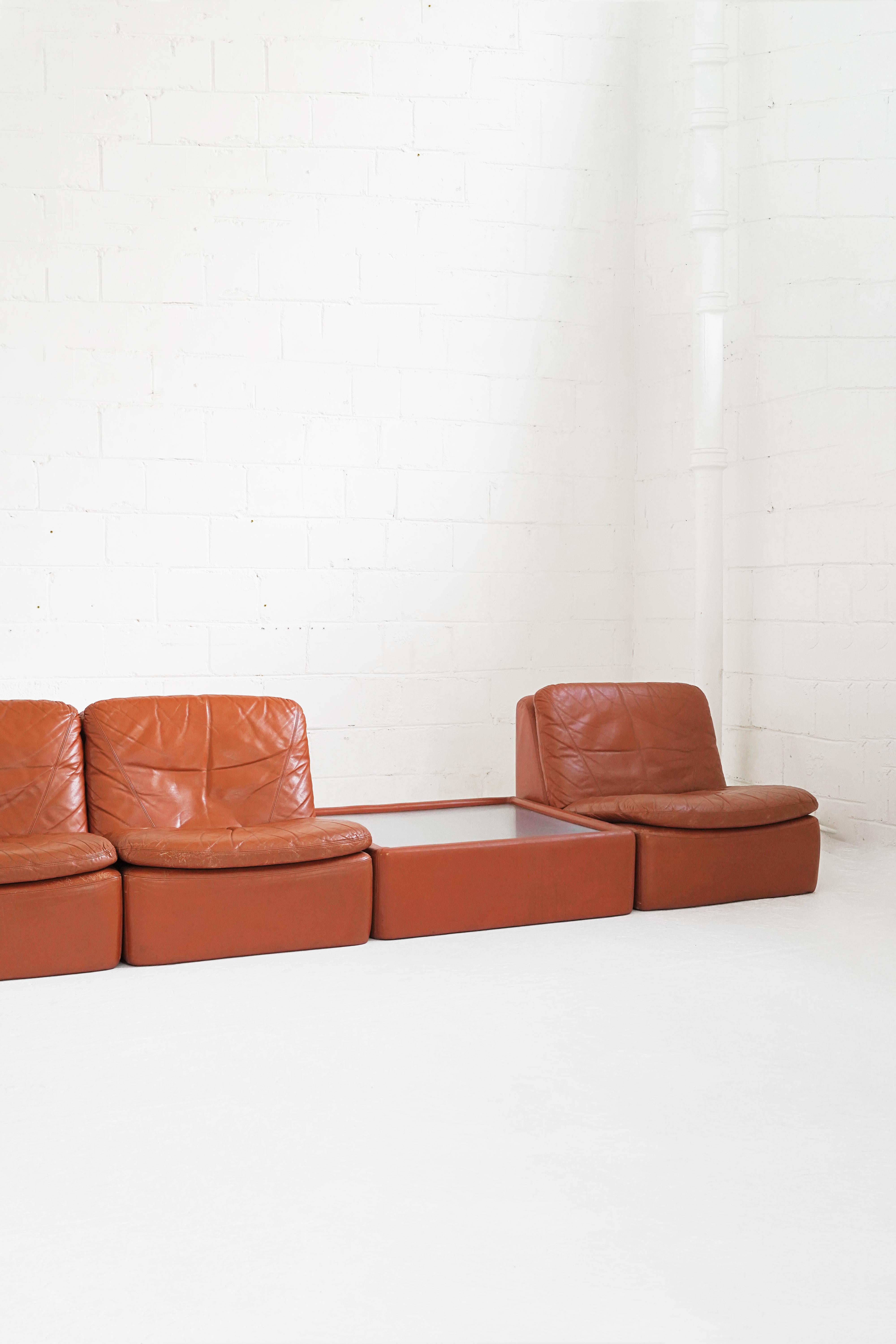 Stunning vintage leather modular set, including 3 seat pieces, 1 ottoman and 1 coffee table. Can configure in multiple designs with coffee table as part of the sectional. 

Seat Section: 25 1/2