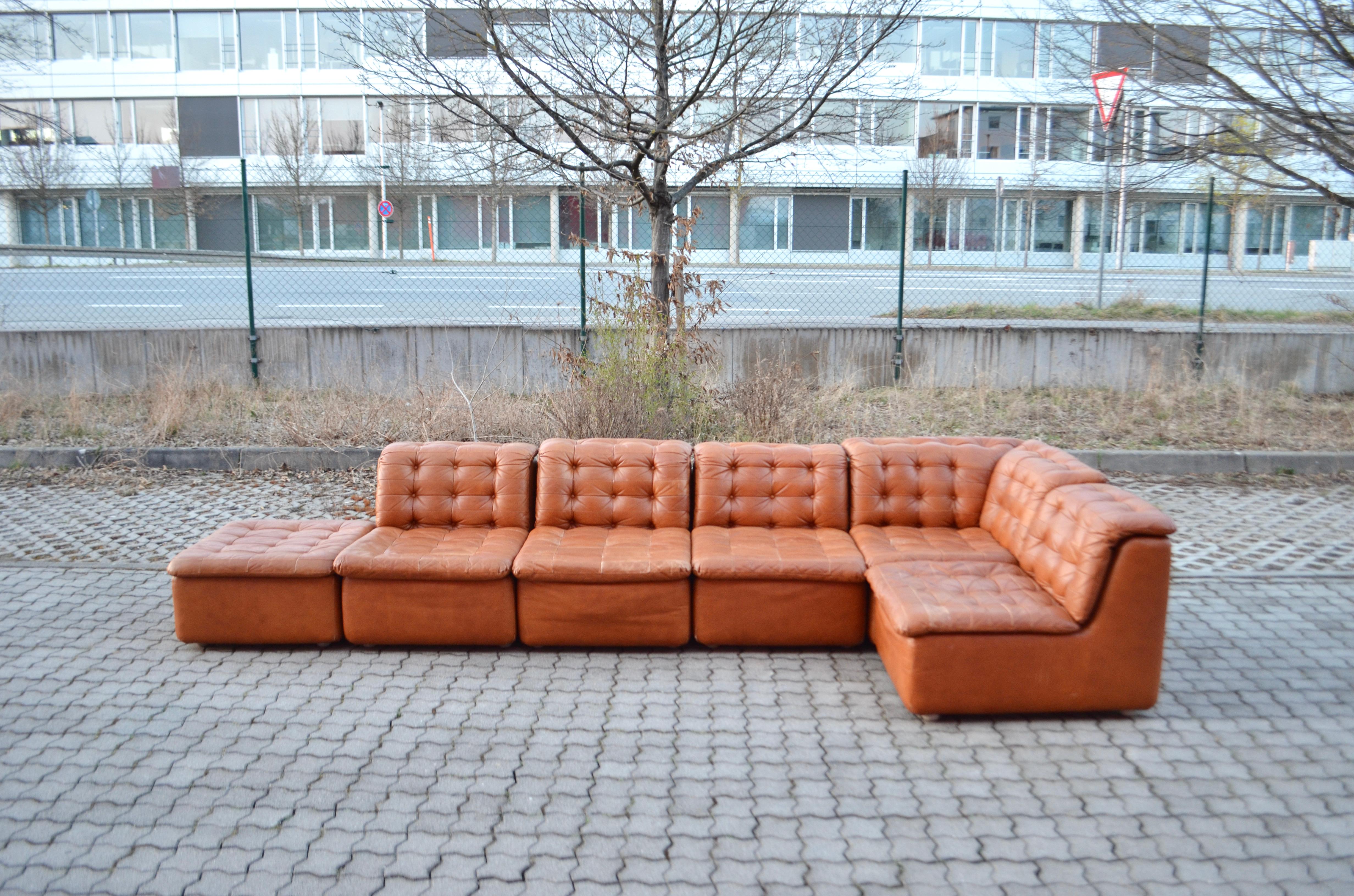This stunning Modular sectional leather sofa is manufactured in Germany.
It is a high quality manufactured seating group.
The producer is yet unknown.
It is a pure 70ties design with timeless modern shape.
The leather is a beautiful brandy