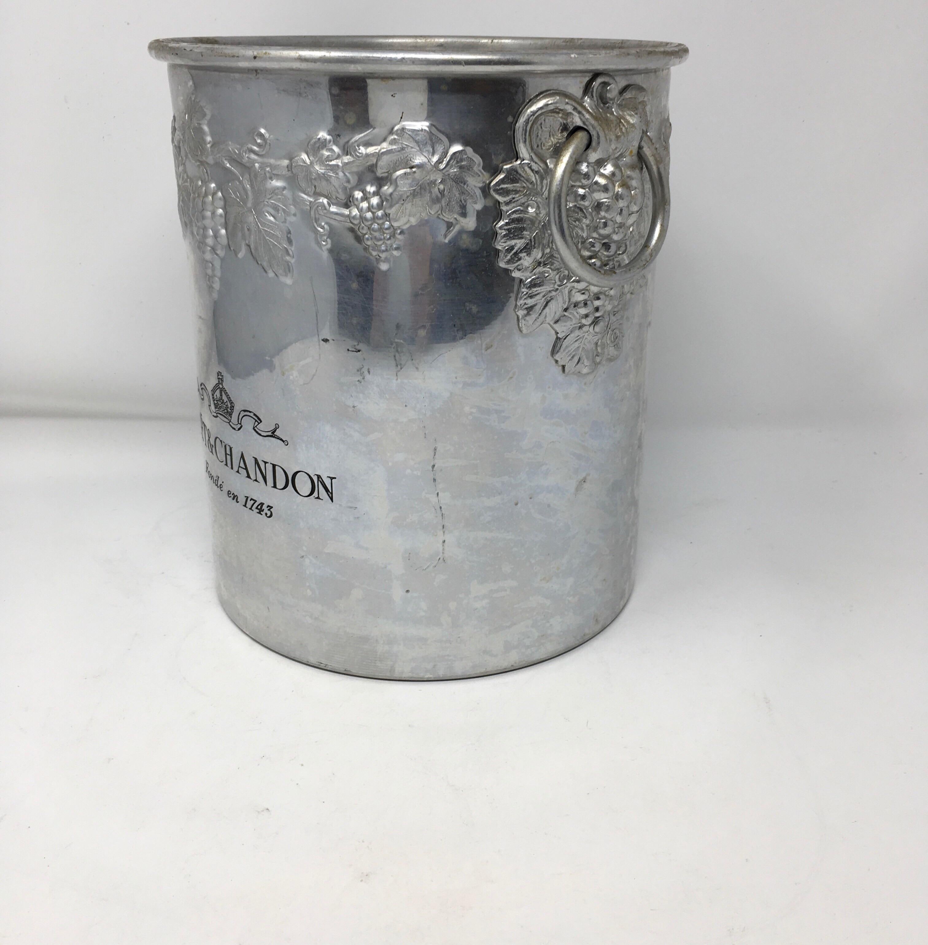 Vintage Moët & Chandon ice/champagne bucket in excellent original condition.
Made in solid pewter with the engraved champagne makers name and logo, Moët & Chandon Fondée en 1743 on the front and is decorated with a ring of grape vine and leaves