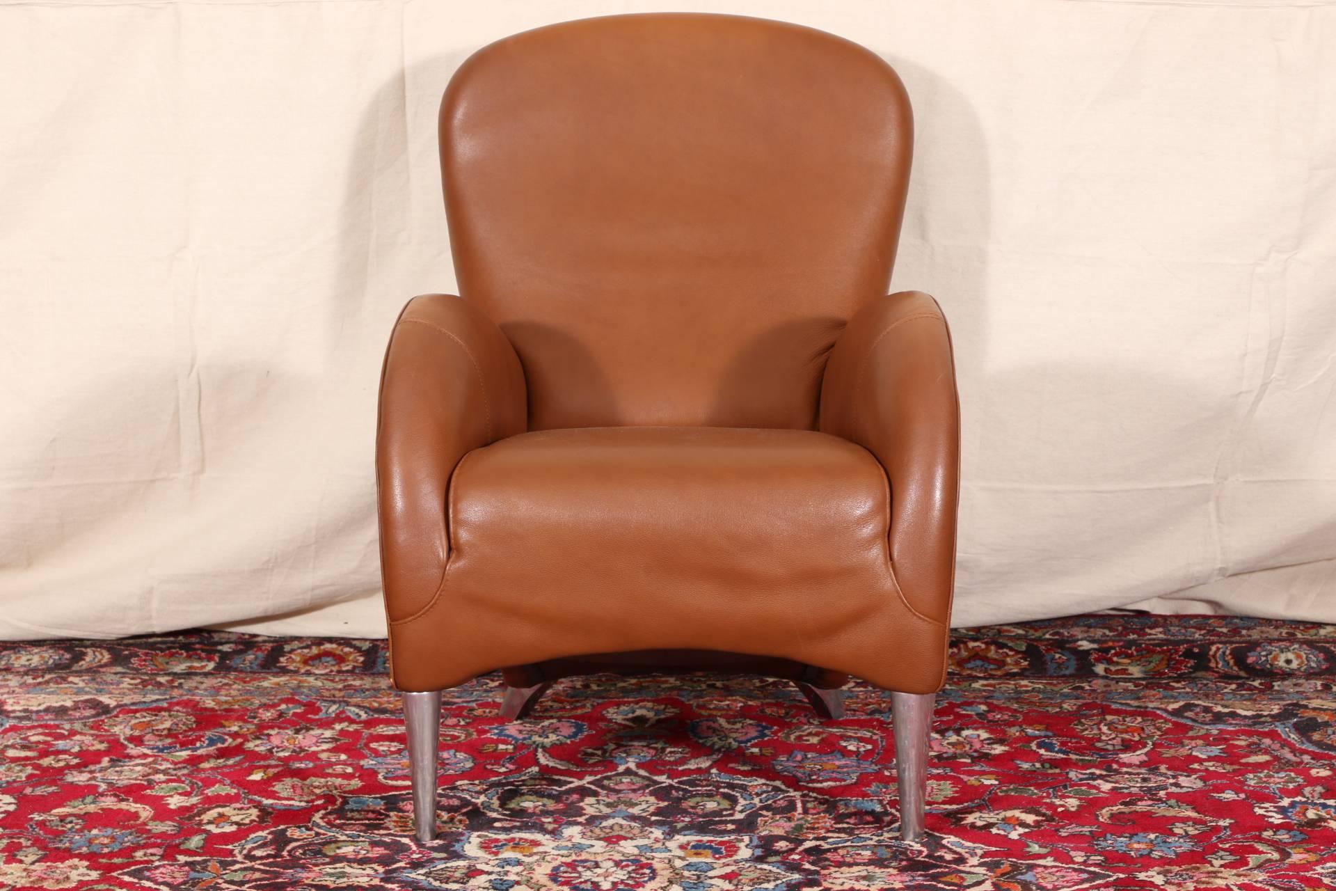 Vintage Molinari tan leather armchair, arched arms and the lower curved frame raised on chrome square shaped legs in front and short splayed ones at back, stamped on the side. 

Condition: Expected wear and signs of use including slight creasing